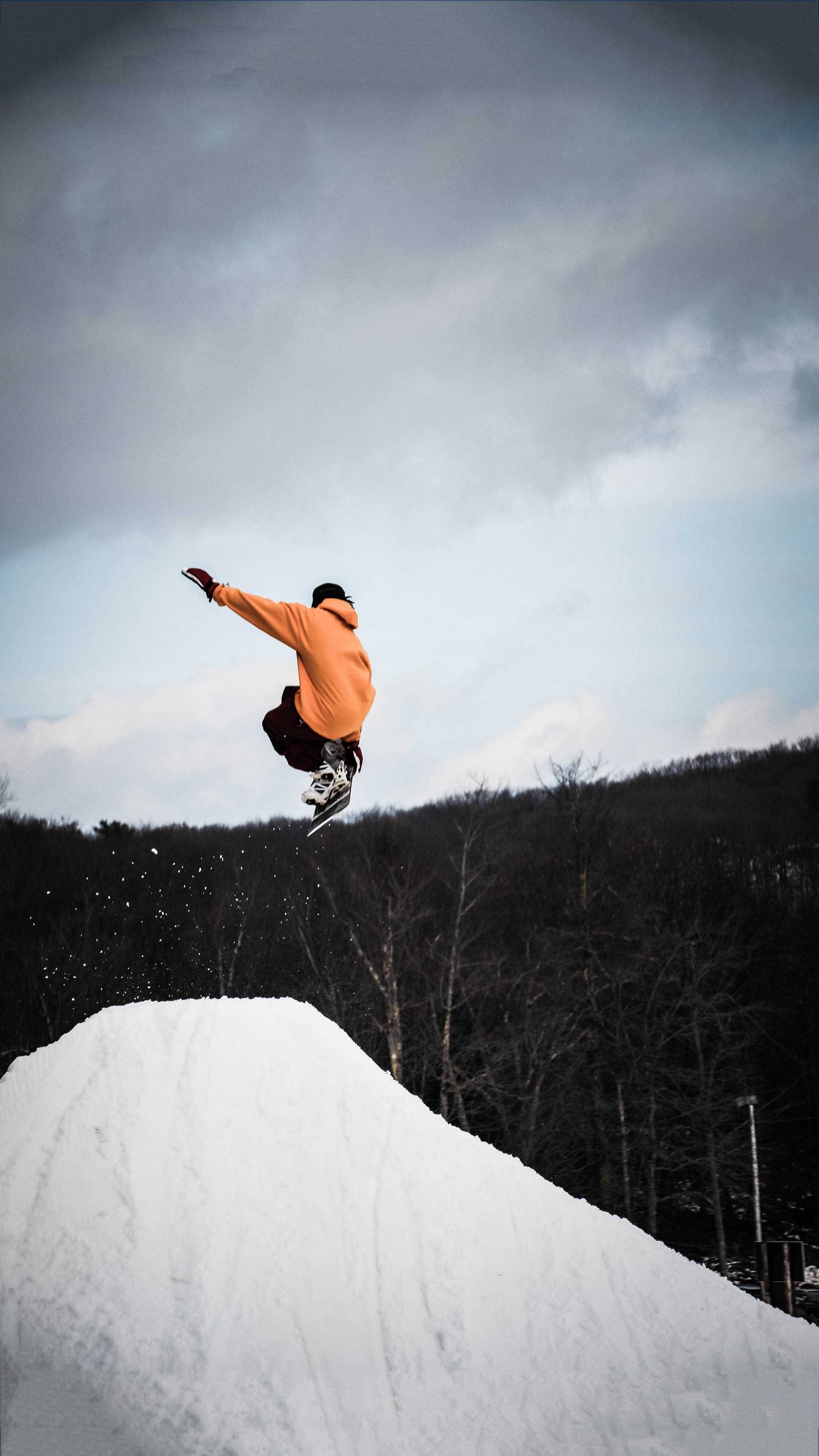 Snowboarding: Slopestyle at a terrain park, Snowboard tricks in the air, Extreme sport. 2160x3840 4K Background.