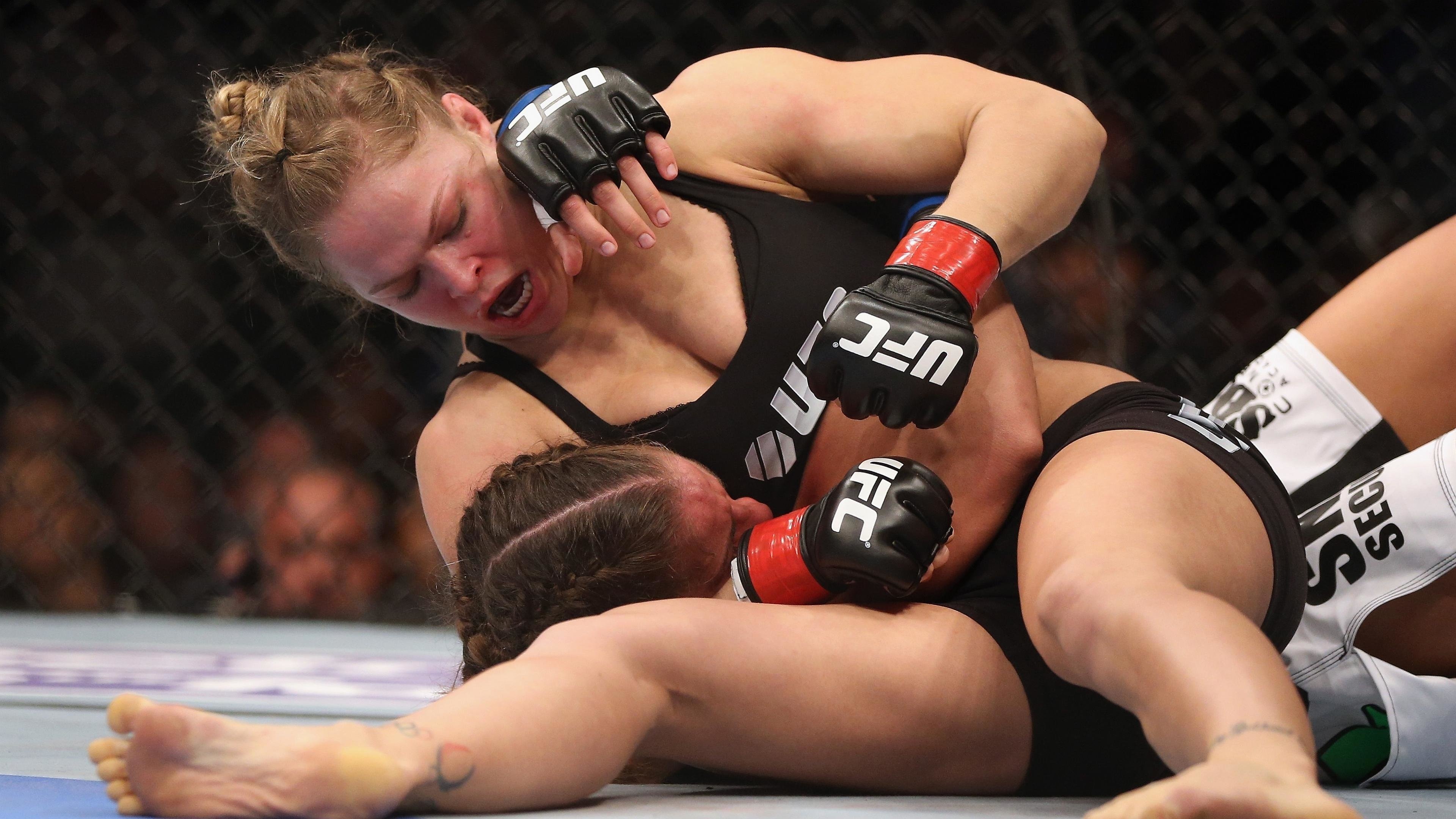 Mixed Martial Arts: Ultimate women fighting, A full-contact combat sport based on striking, grappling and ground fighting. 3840x2160 4K Background.