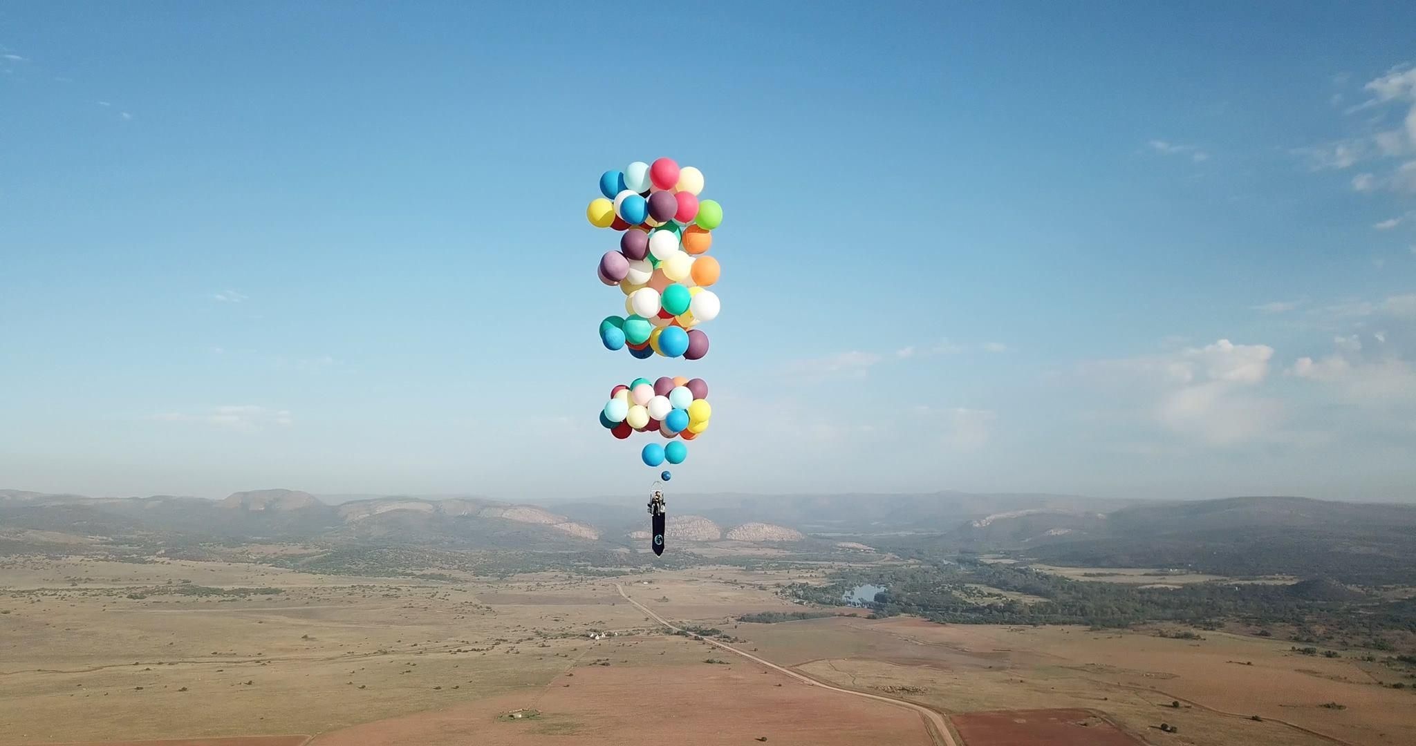 Cluster Ballooning: A flight 8,000 feet up in the air using 100 helium balloons, Tom Morgan flight across South Africa. 2050x1080 HD Background.