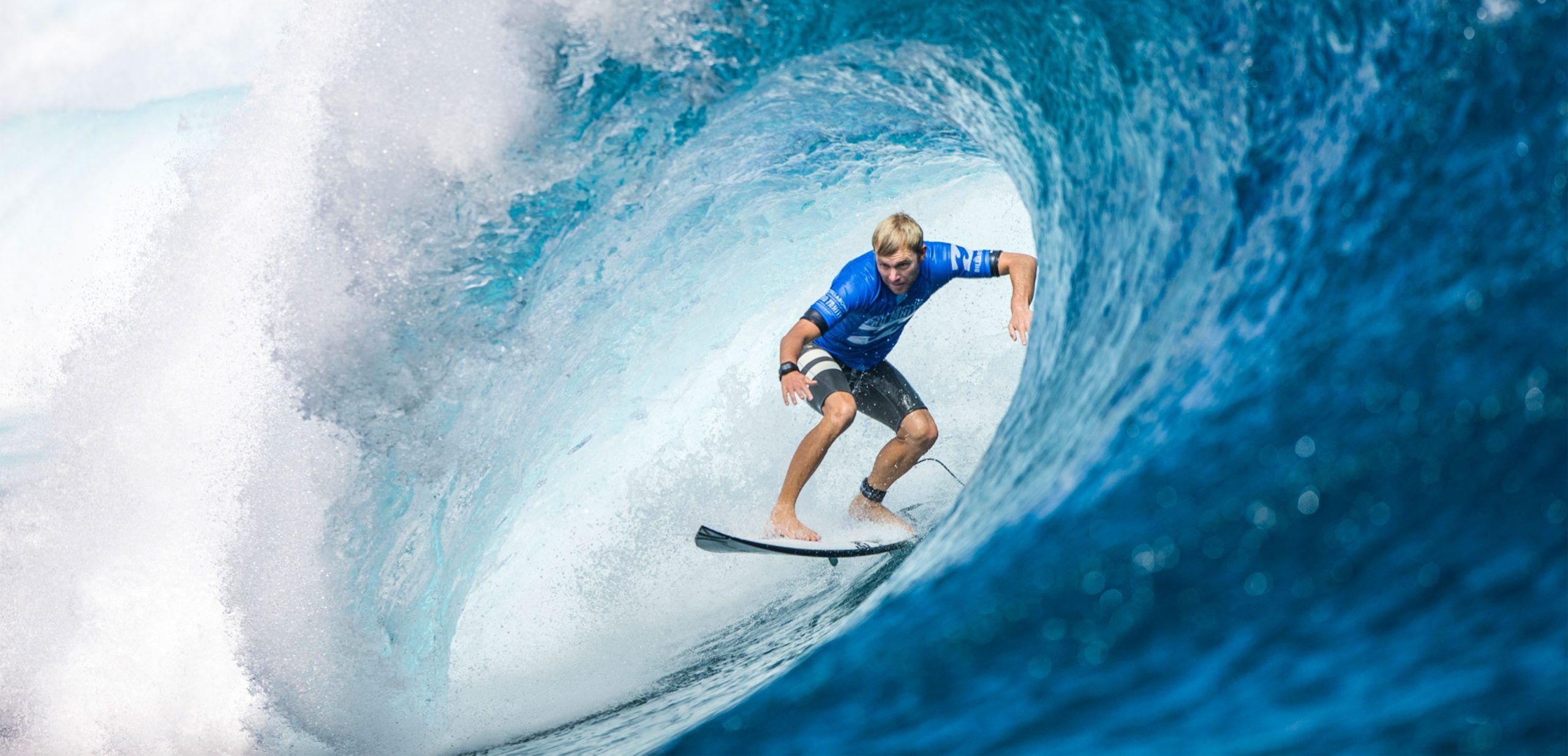 Surfing: World Surf League athlete in French Polynesia, The island of Tahiti. 2560x1240 Dual Screen Background.