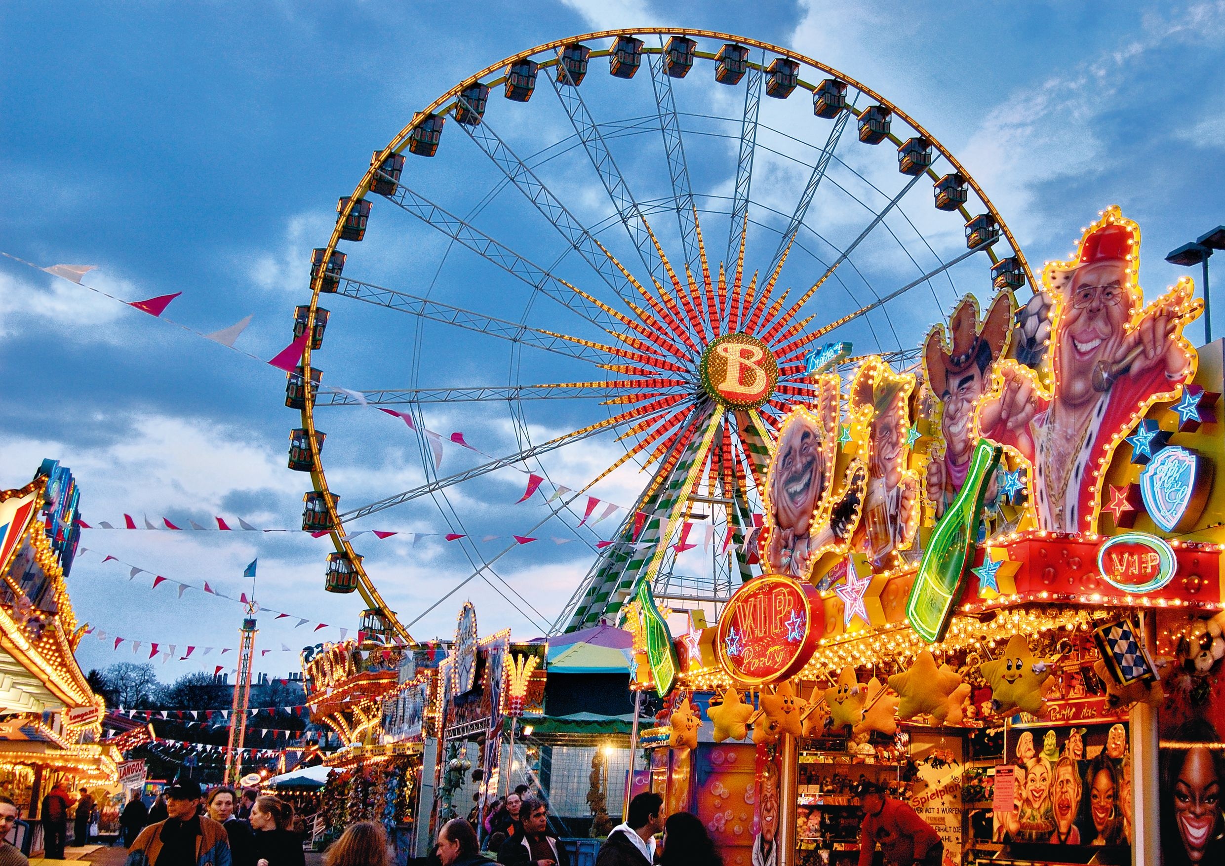 Fun Fair: A large place equipped with recreational devices as Ferris wheels. 2490x1760 HD Background.