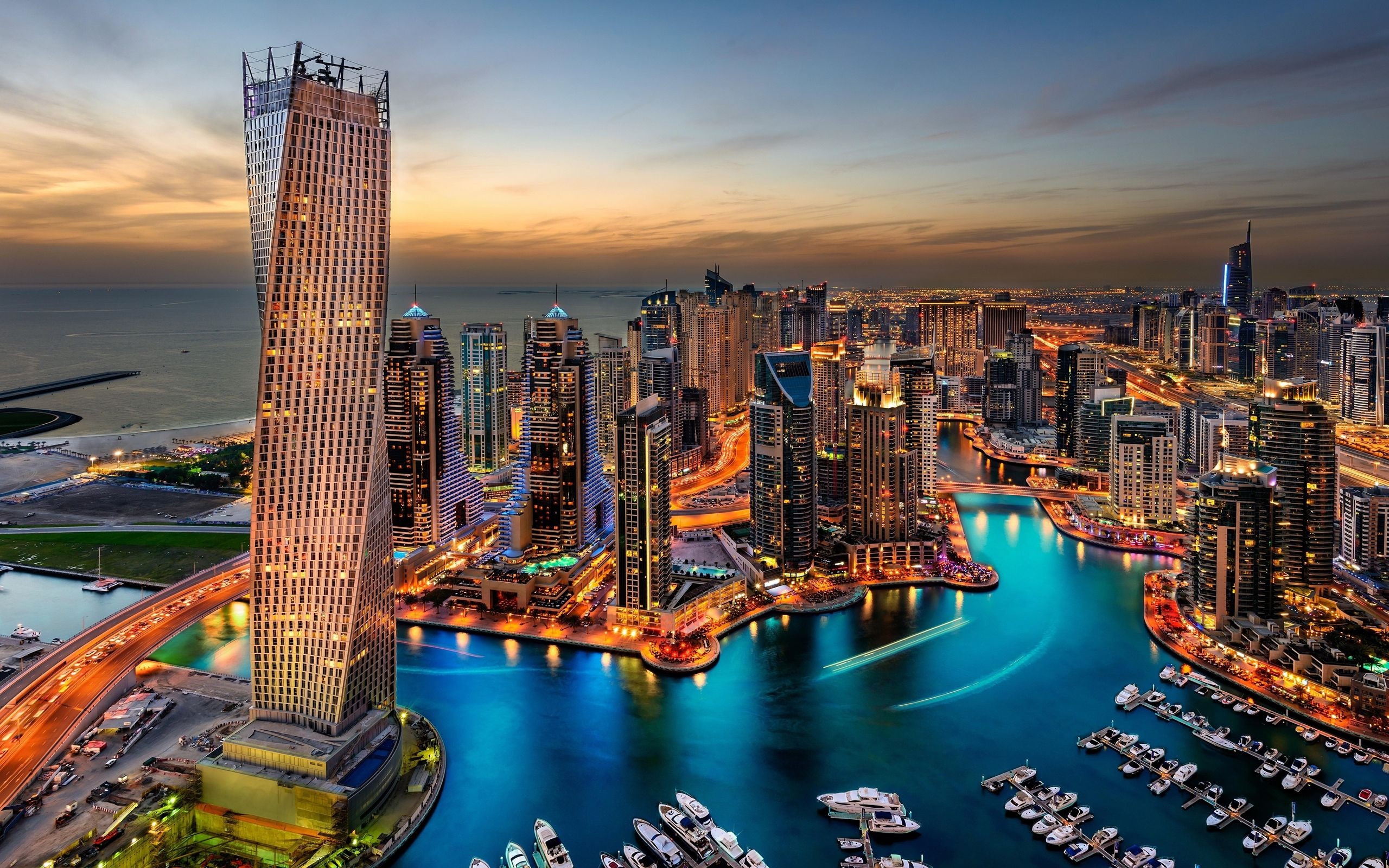 Dubai: Marina, a seven-kilometer palm tree-lined path bordering the neighborhood's popular emerald-hued waterway. 2560x1600 HD Background.