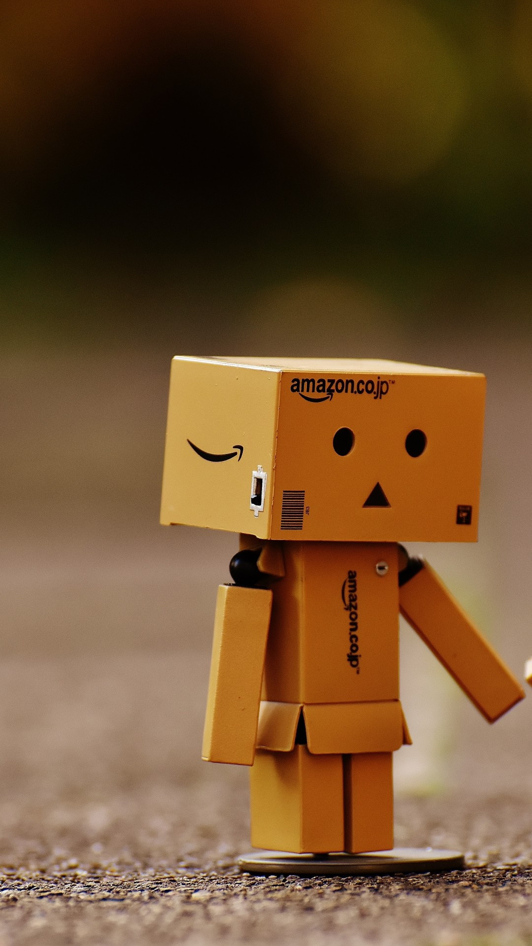 Amazon: Danbo, A fictional cardboard box robot, Acquired Zappos for $850 million in 2008. 1080x1920 Full HD Background.
