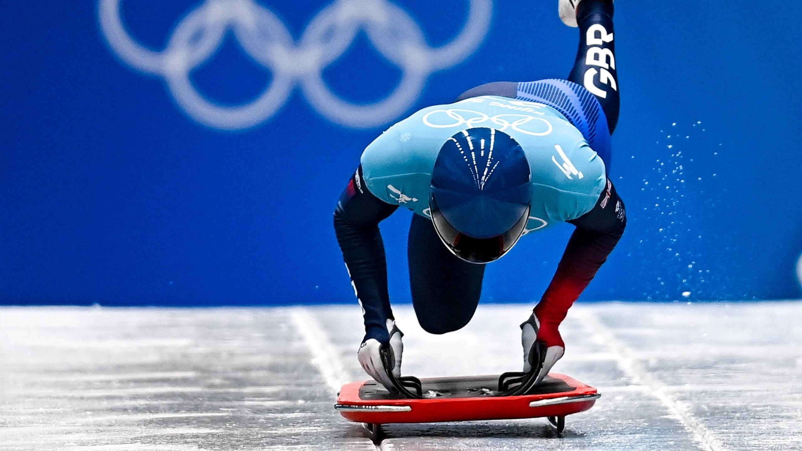 Skeleton (Sport): A British athlete competes at the Beijing 2022 Winter Olympic Games. 2560x1440 HD Background.