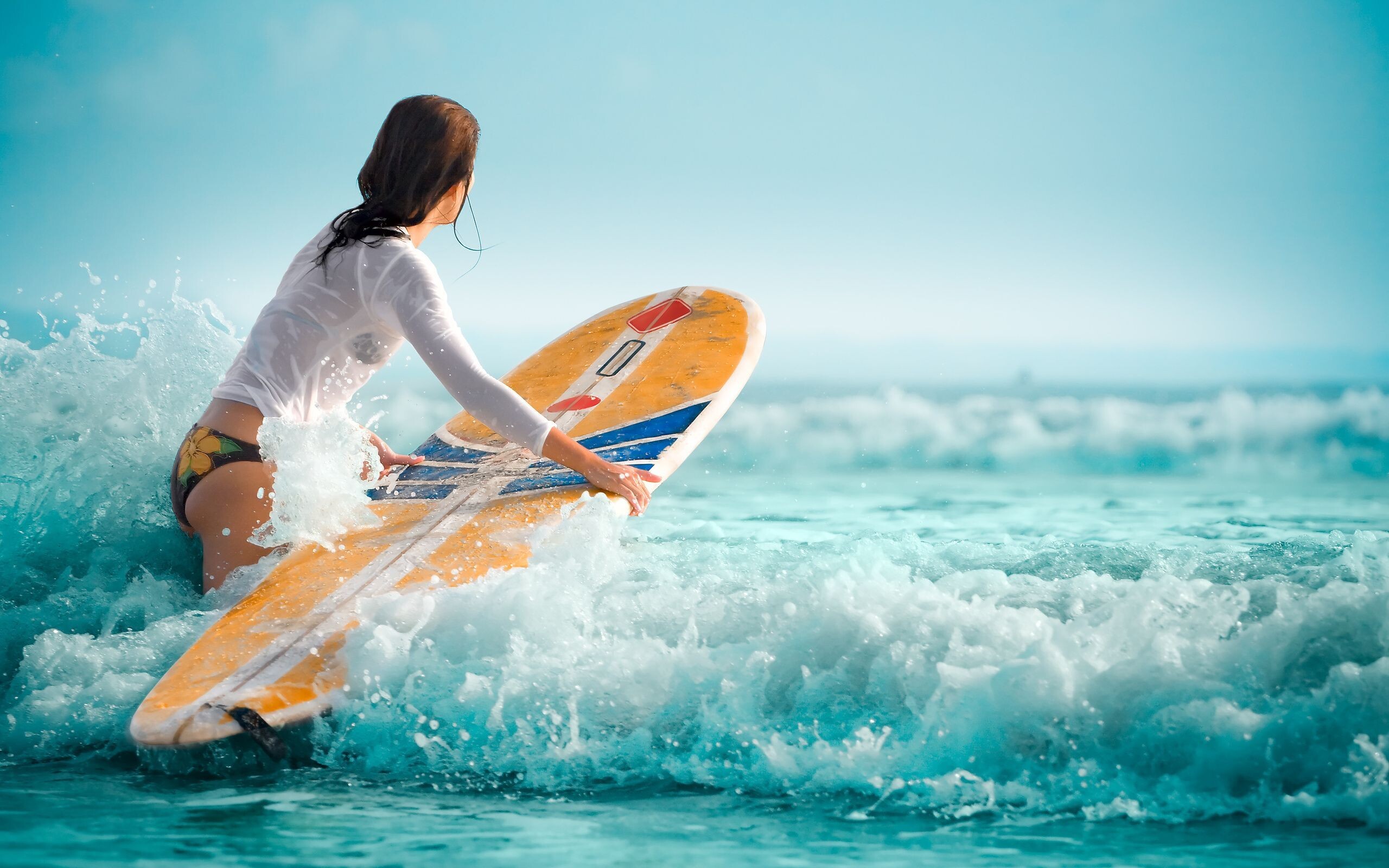 Girl Surfing: High-risk water sport, Women riding a surfboard, Ocean shore longboarding. 2560x1600 HD Background.