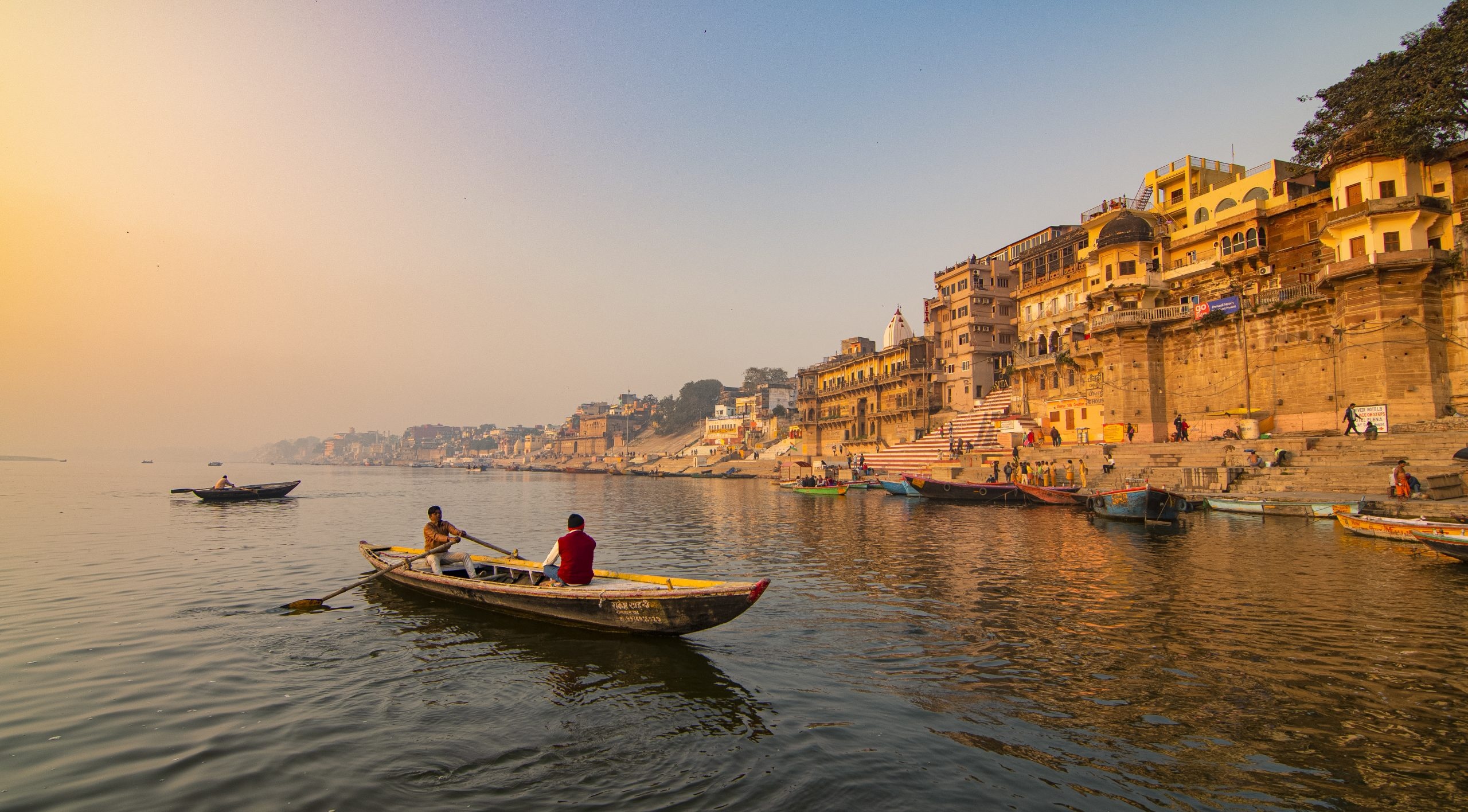 Skiff: A river craft used for leisure, Varanasi. 2560x1420 HD Wallpaper.