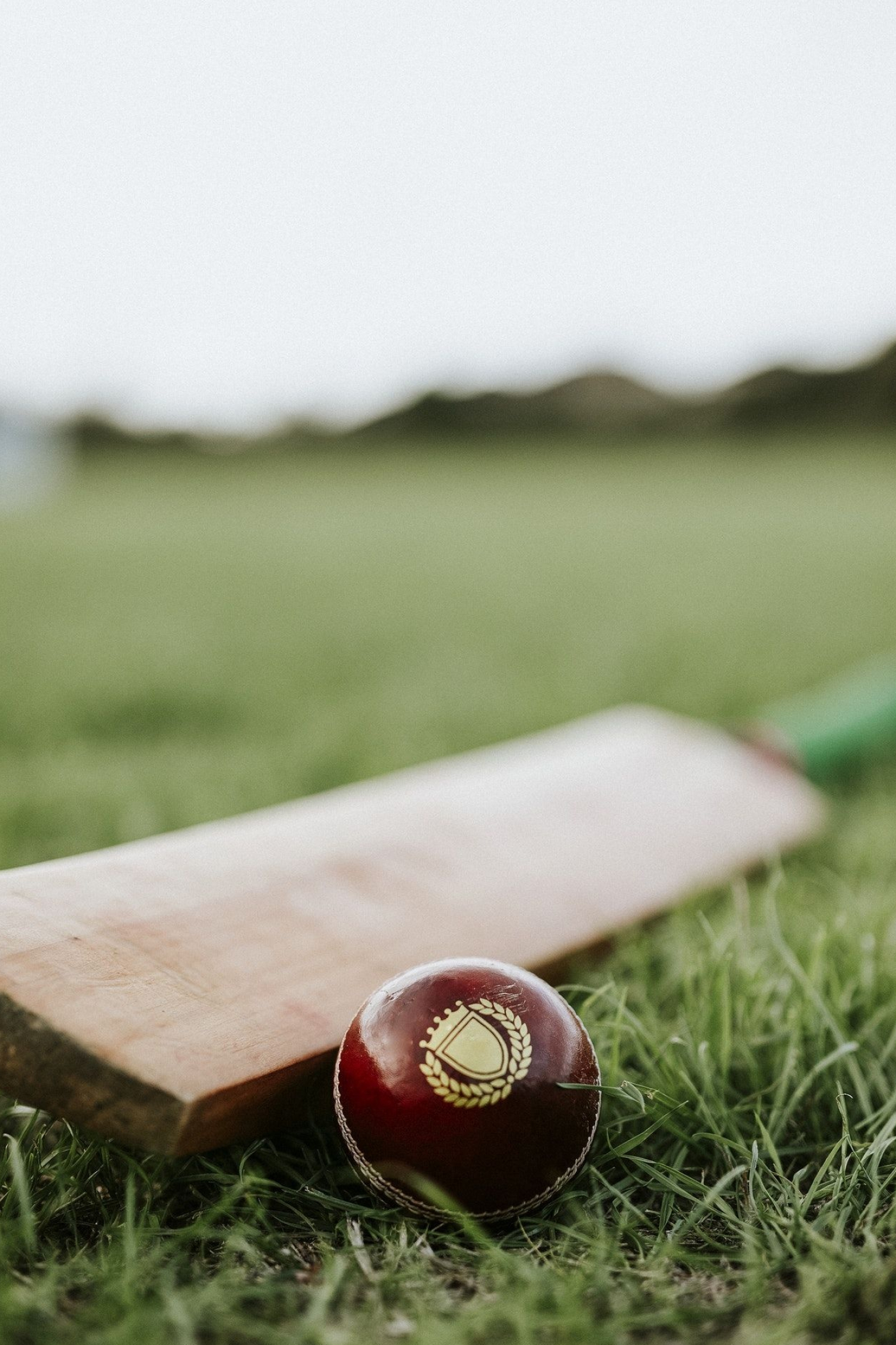 Cricket: A bat and a ball, Manufacture is strictly regulated by cricket law at first-class level. 1400x2100 HD Background.