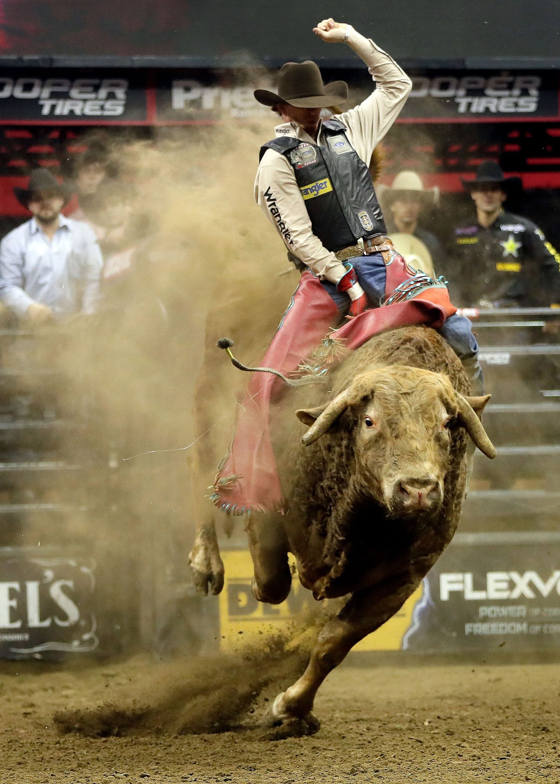 Bullriding: A rodeo sport in which the rider tries to hold on to a bucking bull. 1800x2520 HD Background.