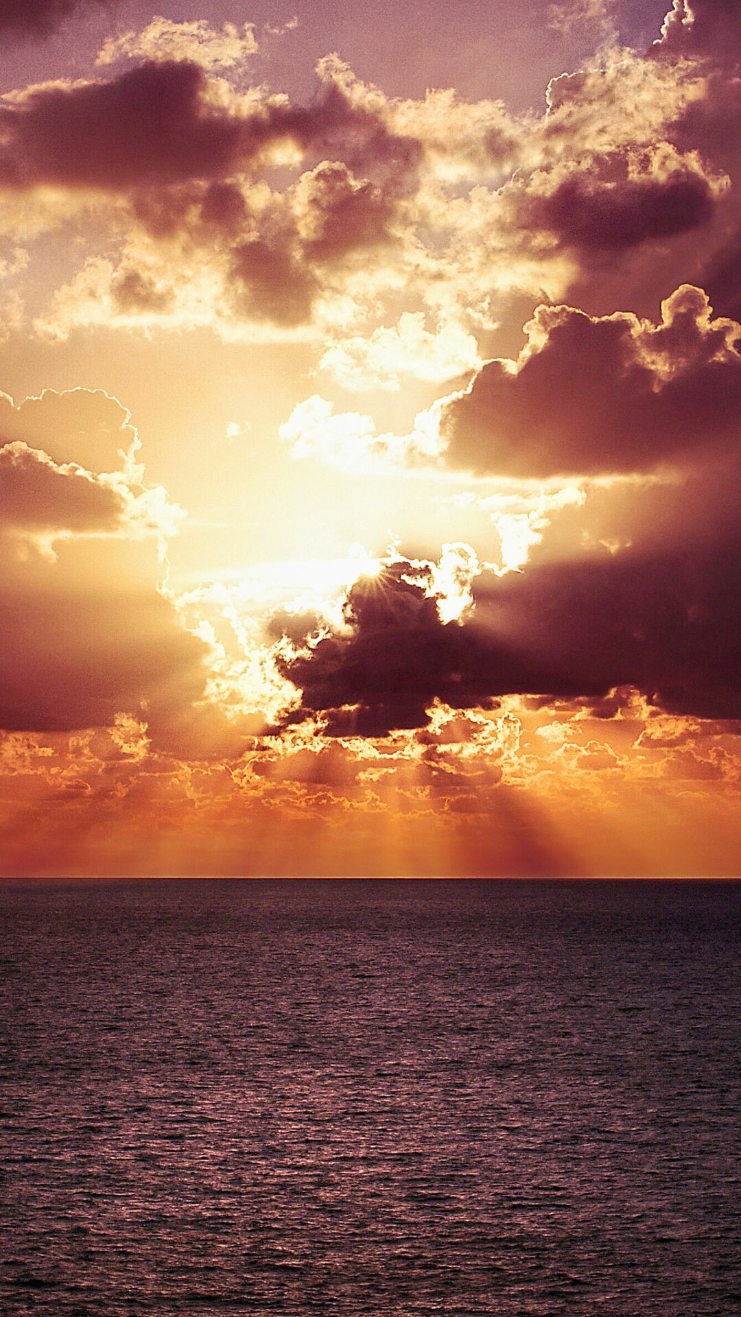 Sunrise: Crack of dawn, The sun breaking through a dark-bottomed cloud. 1080x1920 Full HD Wallpaper.