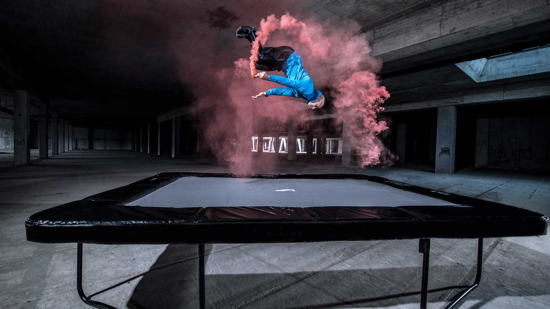 Trampolining: Air painting artistic acrobatic performance by a professional trampoline jumper. 1920x1080 Full HD Background.