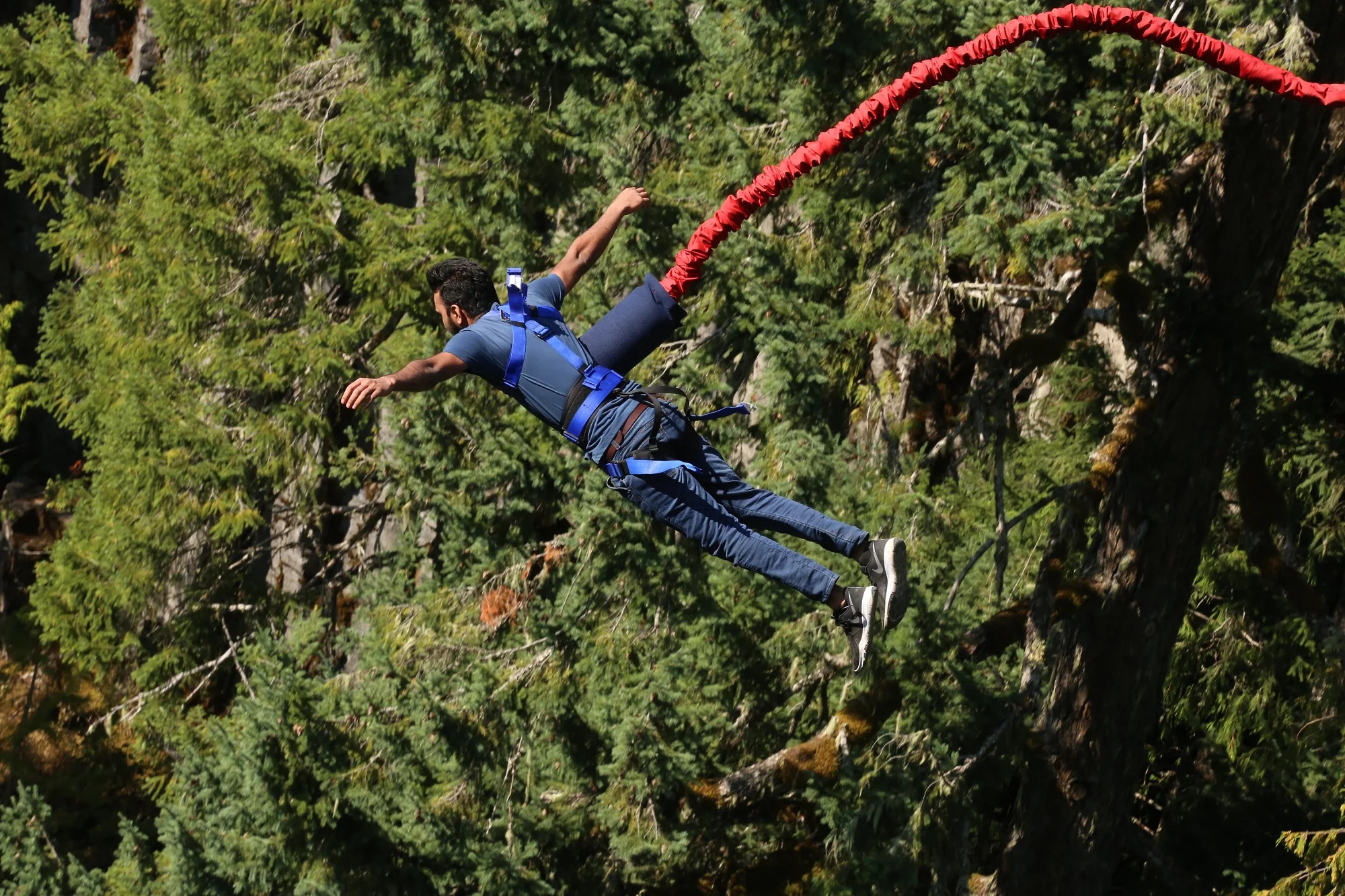 Bungee Jumping: An activity that involves a person falling from a great height while connected to a large elastic cord. 2000x1340 HD Background.