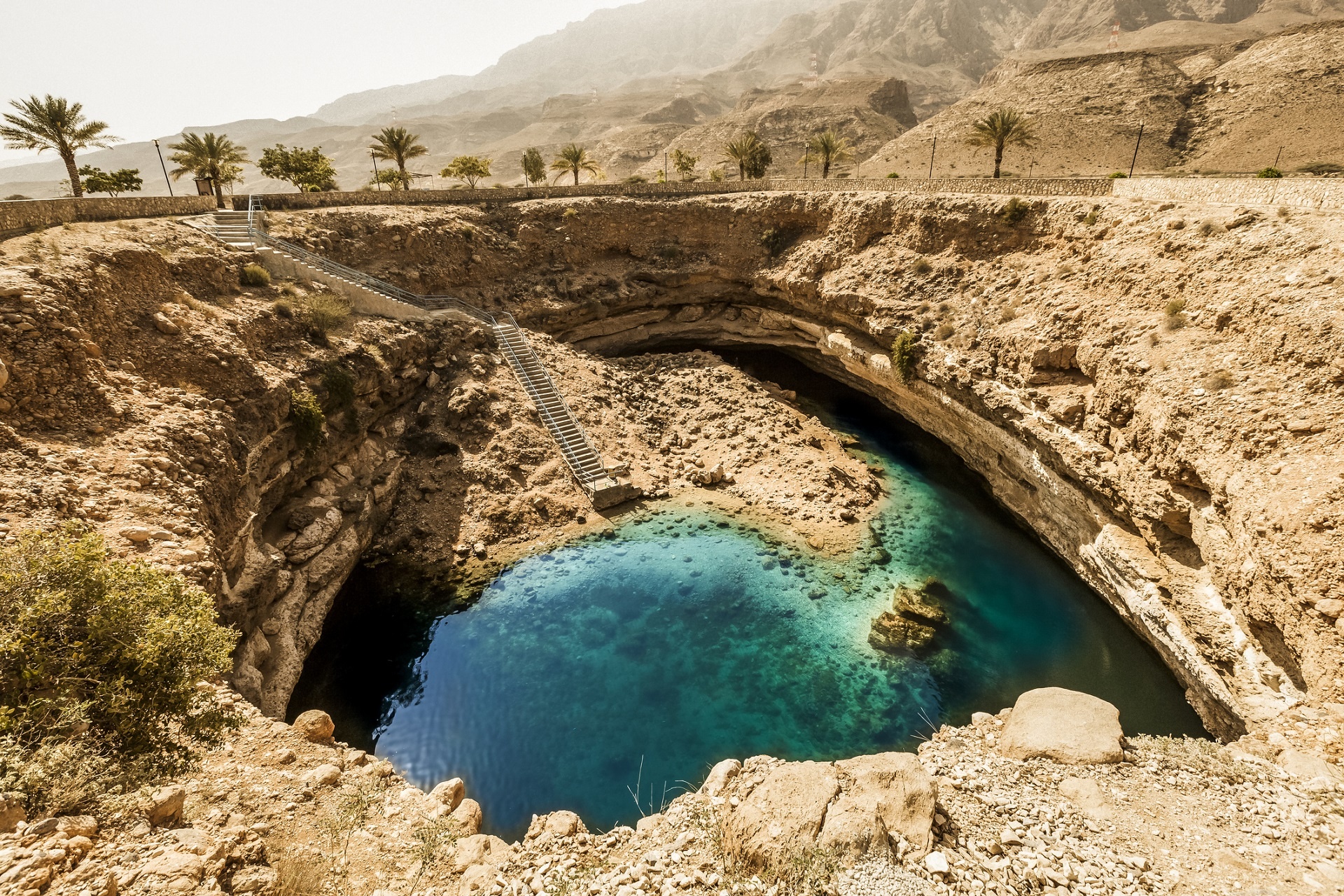 Oman: The Bimmah Sinkhole, a natural limestone crater filled with turquoise water. 1920x1280 HD Background.