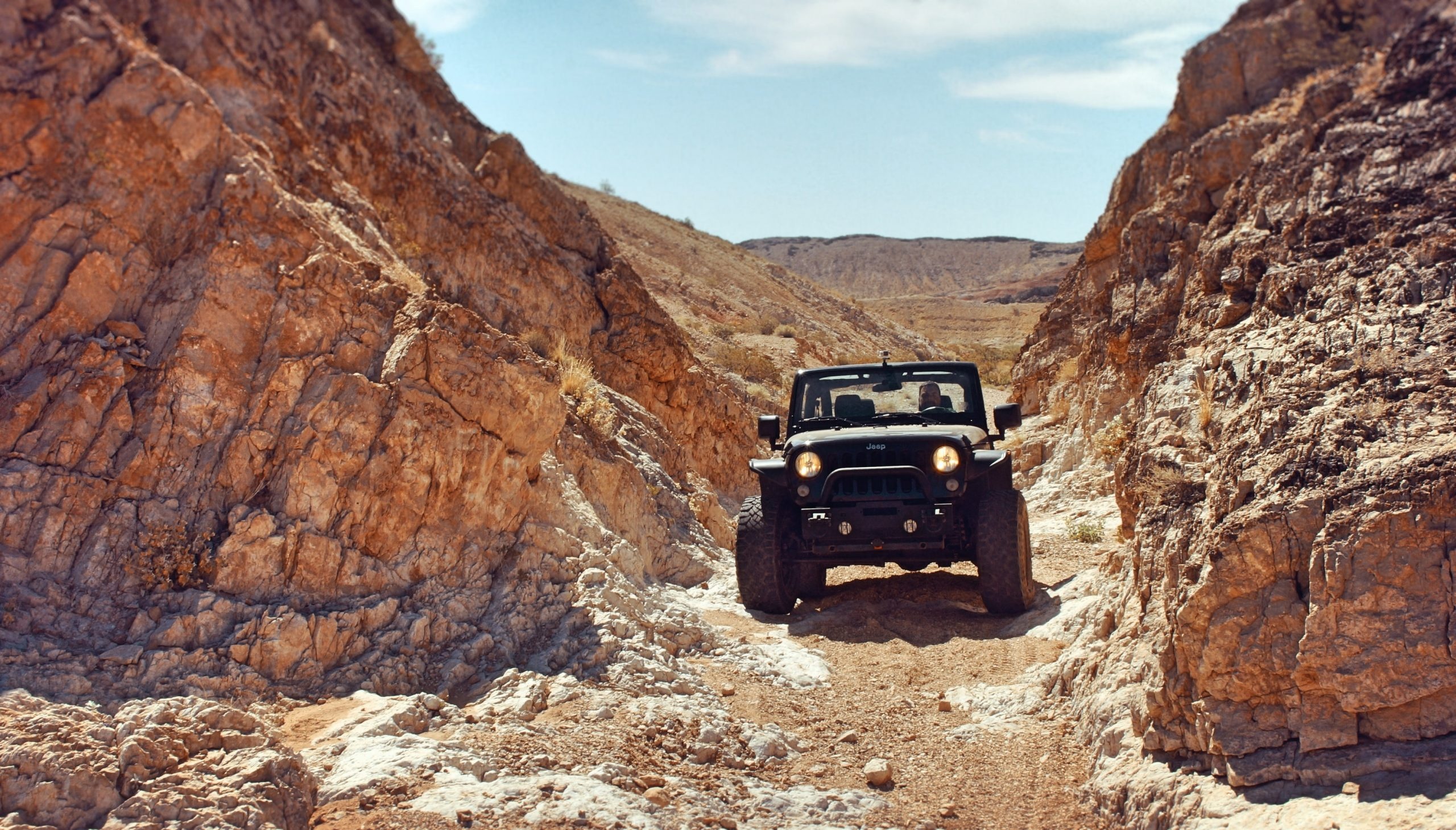Off-road Driving: Rock racing, Vehicles driven over rocks, SUVs with higher ground clearance. 2560x1460 HD Wallpaper.