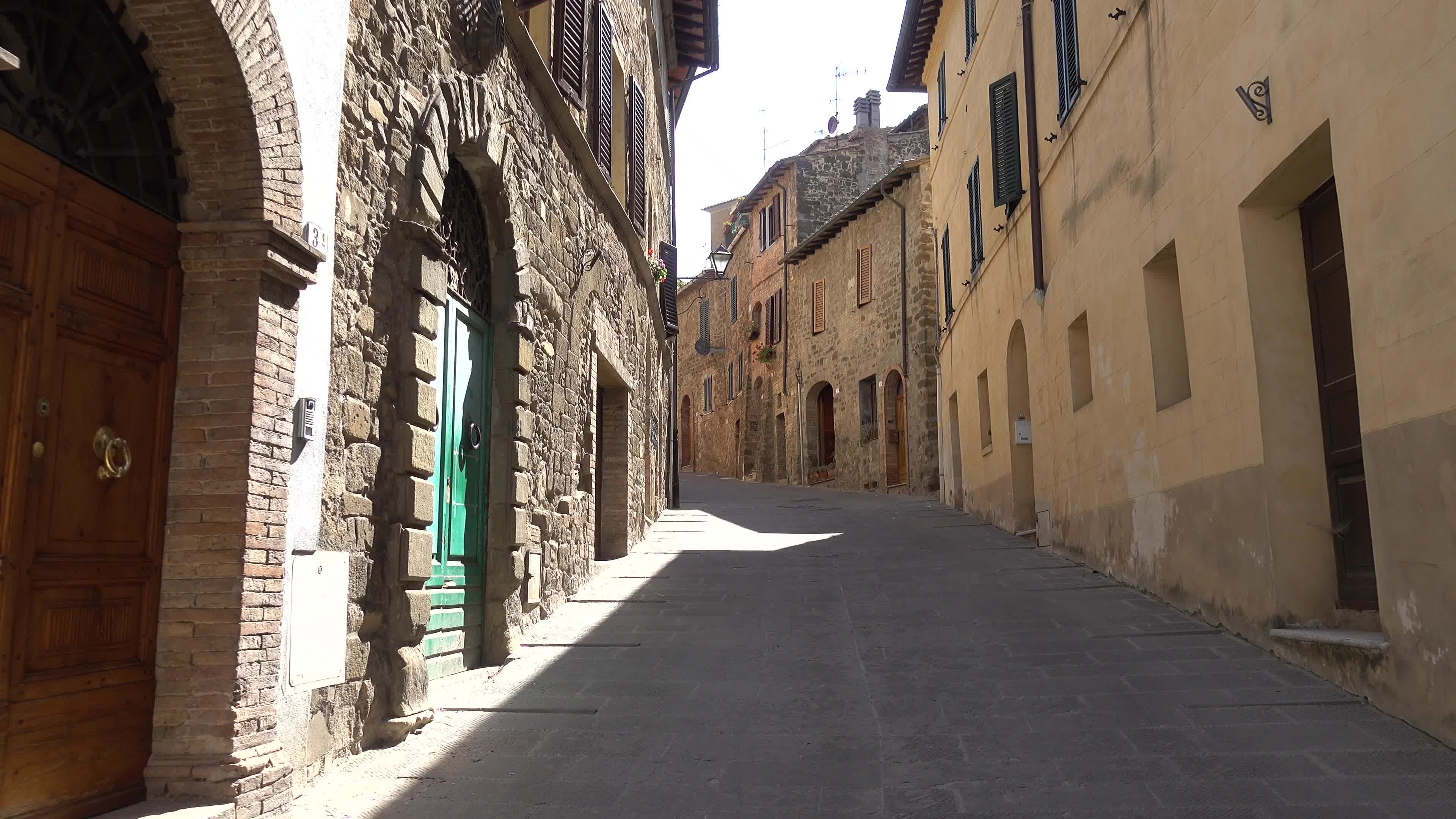 Alley: Cobblestone street and medieval architecture in the village of Montalcino, Tuscany, Italy. 3840x2160 4K Wallpaper.