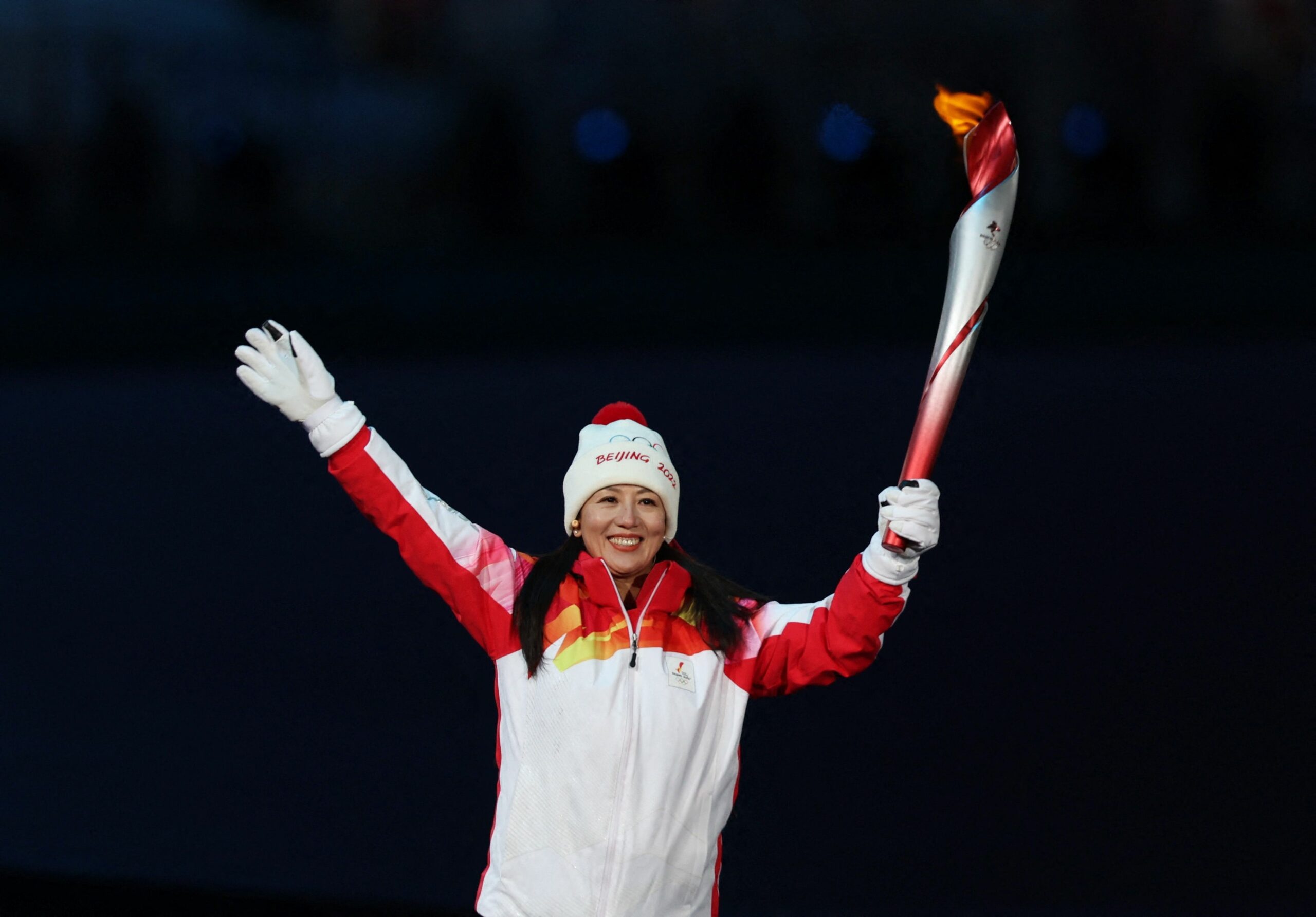 Olympic Flame: Dinigeer Yilamujiang, An Uyghur cross-country skier, A Chinese athlete to light the flame, Olympic Torch. 2560x1790 HD Background.