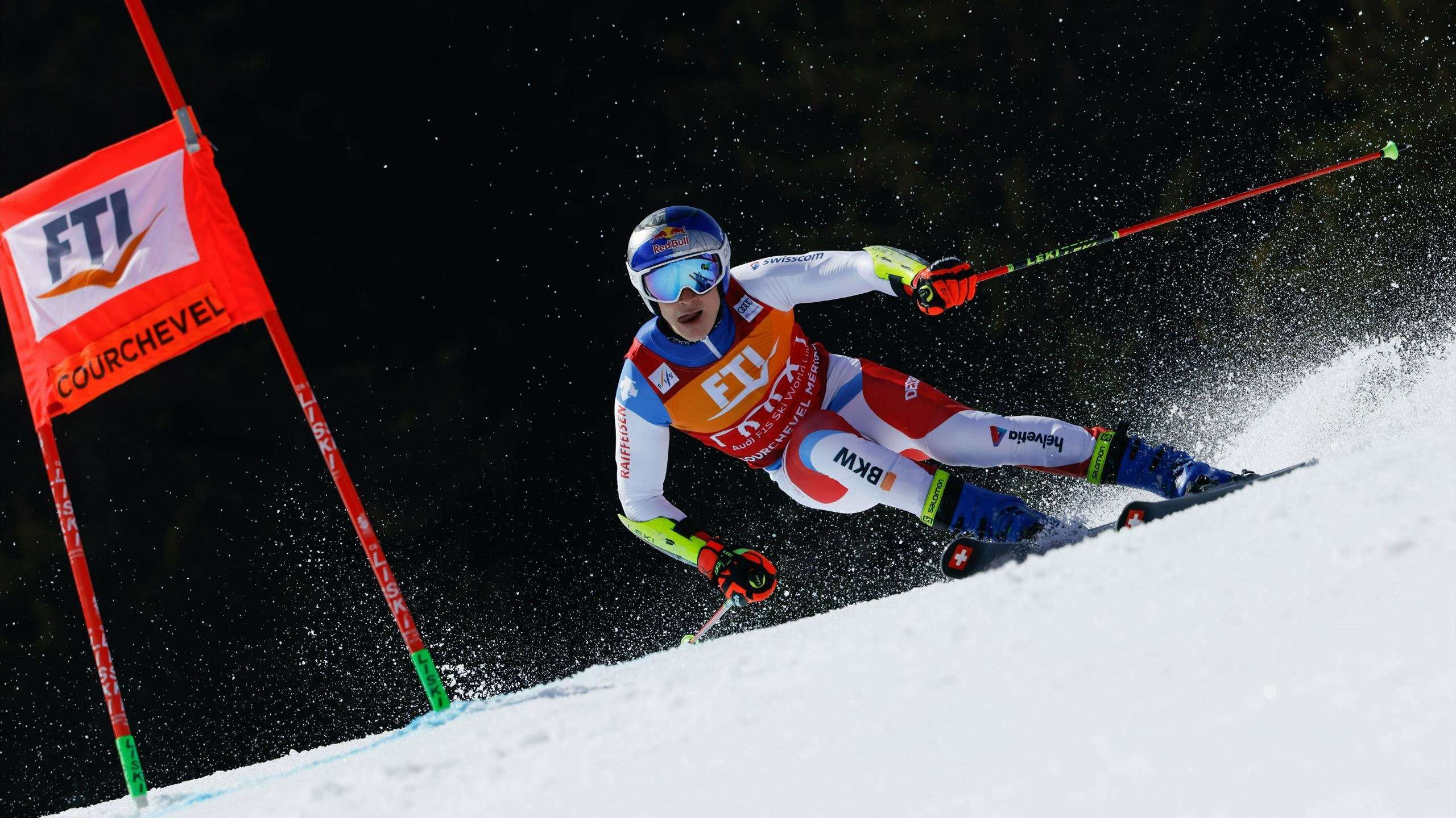 Alpine Skiing: Downhill in a zigzag over a snow-covered track, Race between poles and gates. 2560x1440 HD Background.