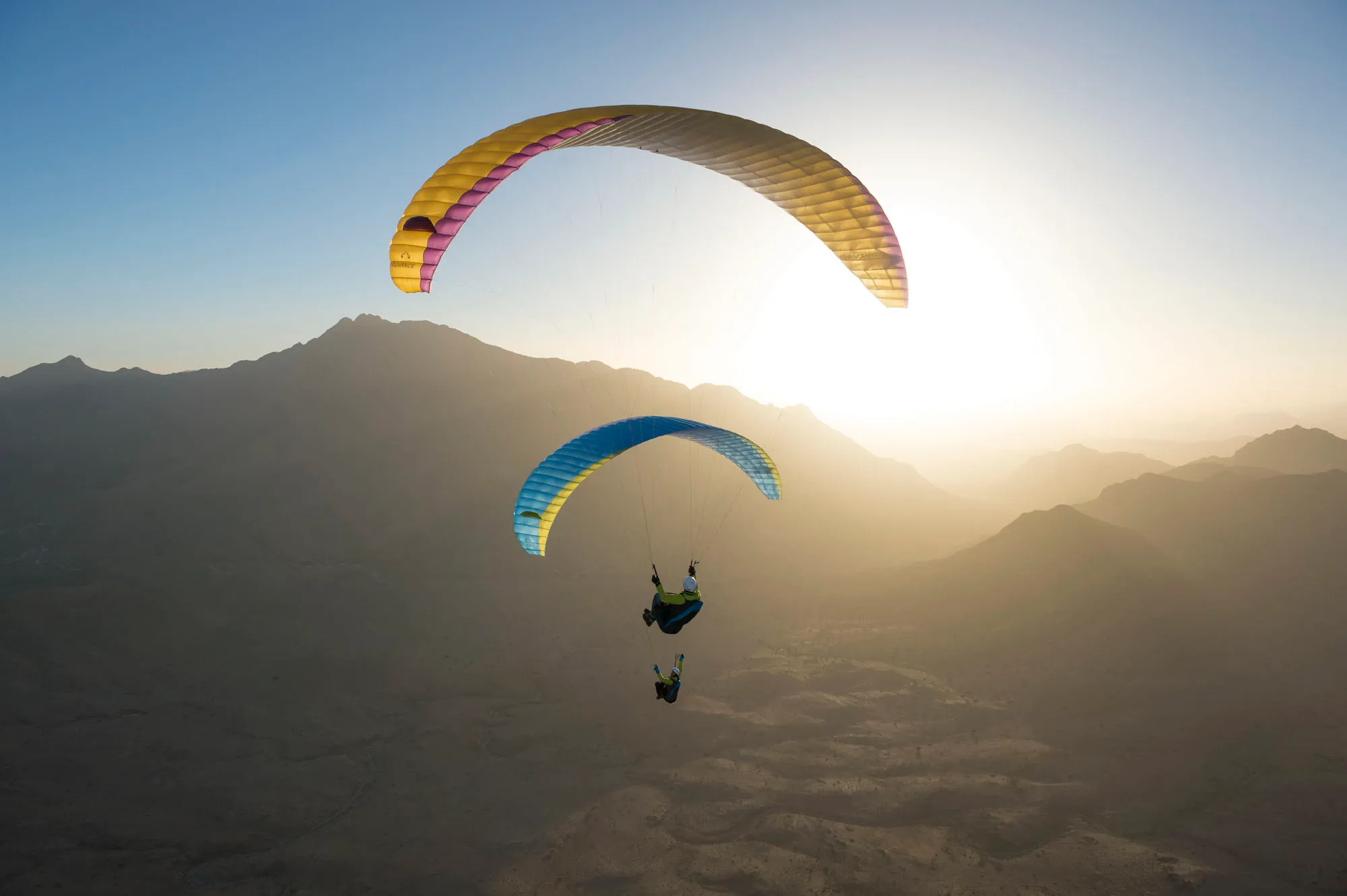 Paragliding: Couple flying paragliders, Ultralight aviation in air sports. 2000x1340 HD Background.