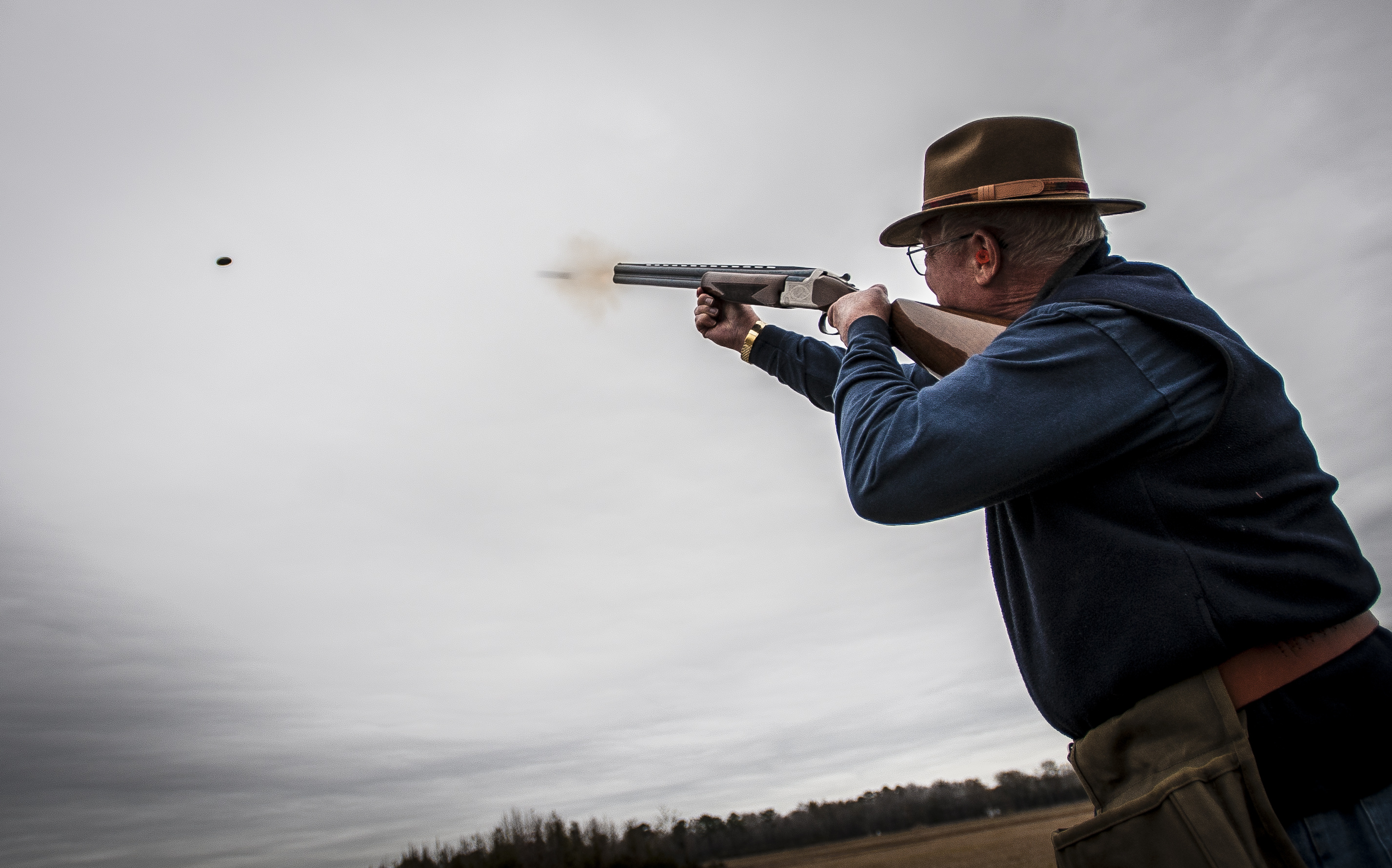 Skeet Shooting: Lee Hunt, a World War II veteran, shoots a flying target with a double-barreled shotgun. 2860x1790 HD Background.