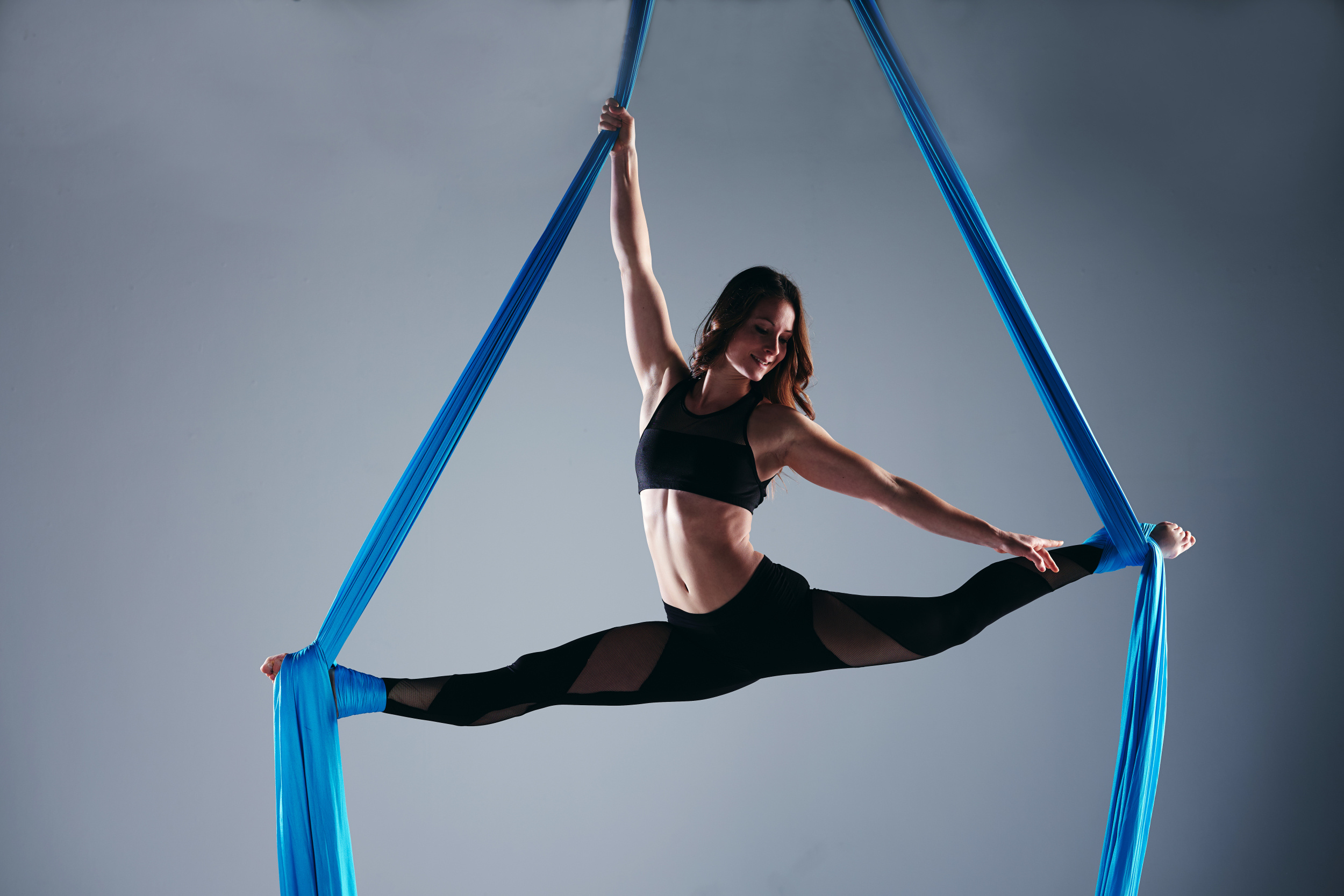 Aerial Silks: A gymnast performs leg-split while hanging from a fabric. 2500x1670 HD Wallpaper.