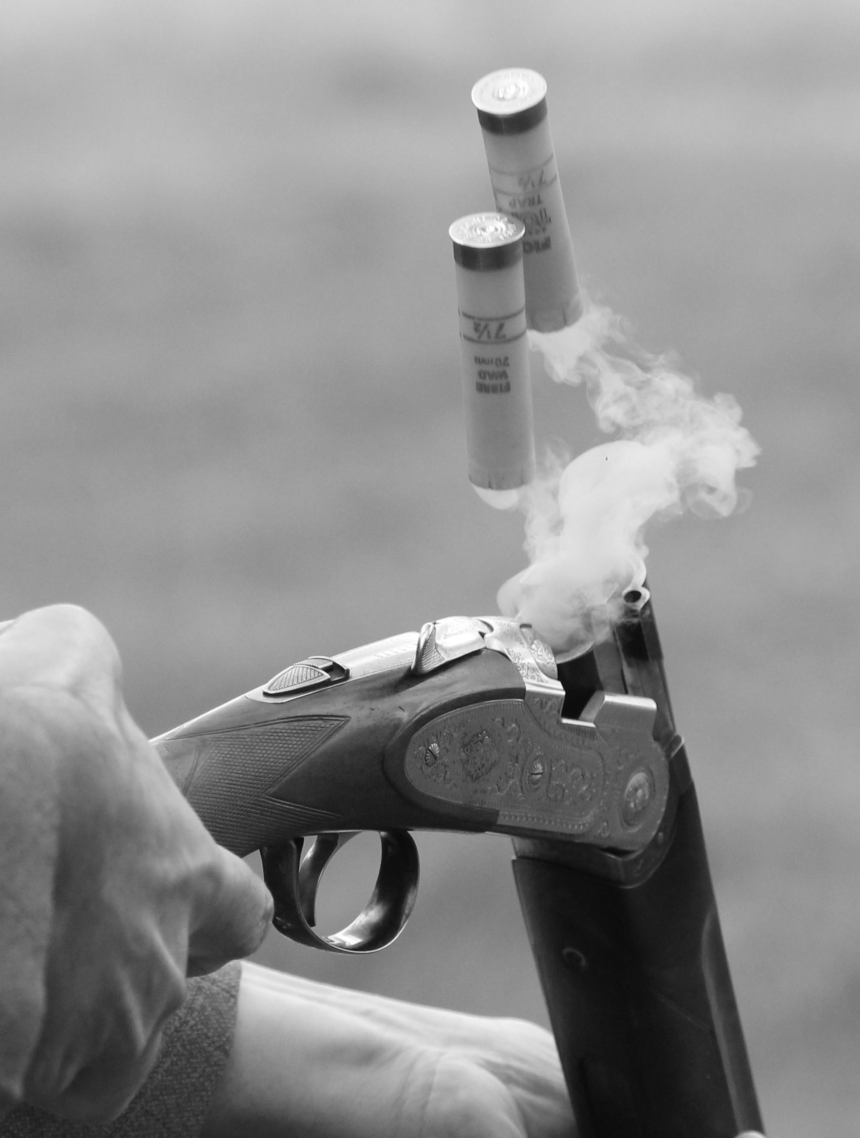 Skeet Shooting: Monochrome shell ejection, Break action double-barreled shotgun. 1710x2250 HD Background.