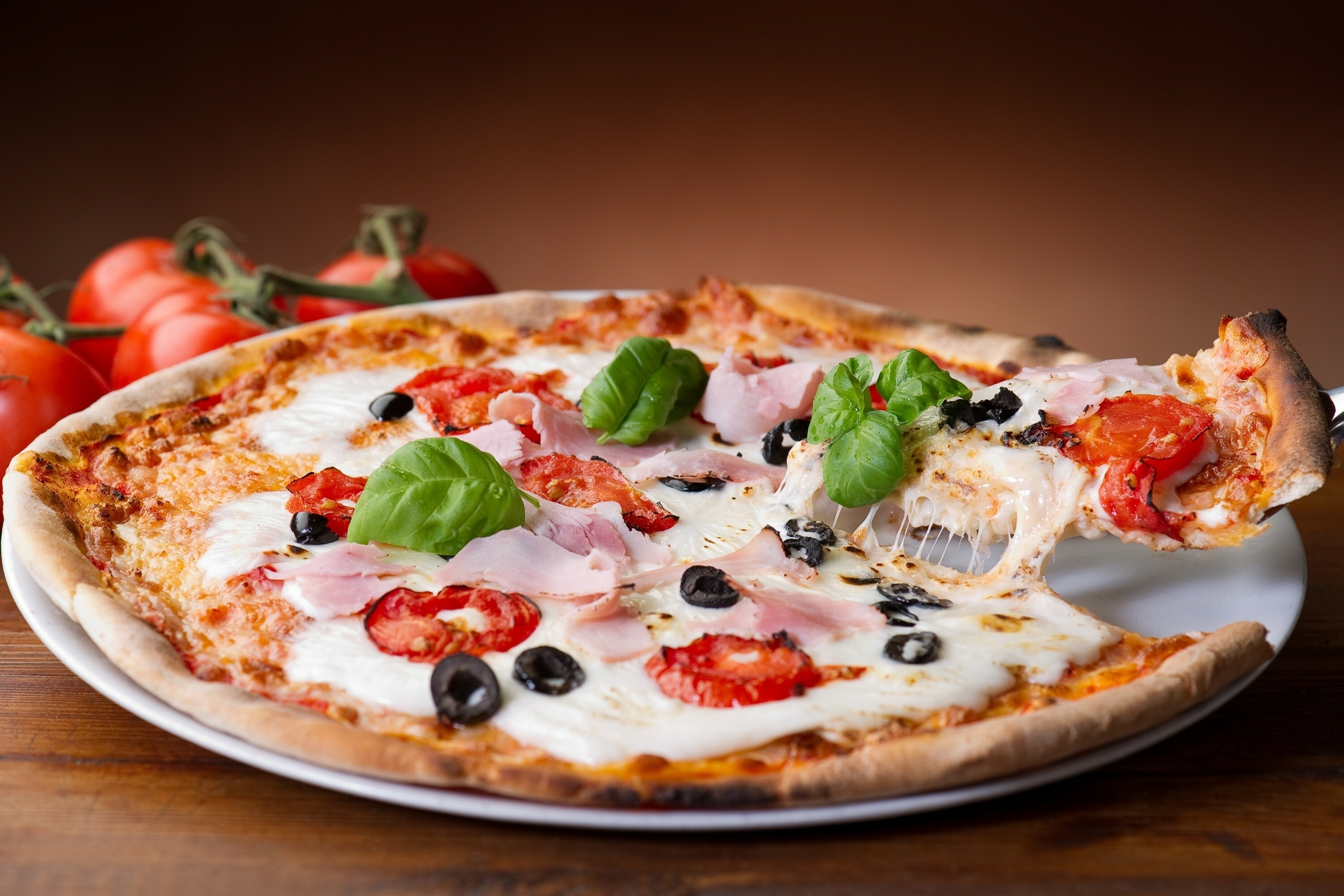 Pizza: A dish topped with tomatoes, basil, and mozzarella. 3000x2000 HD Wallpaper.