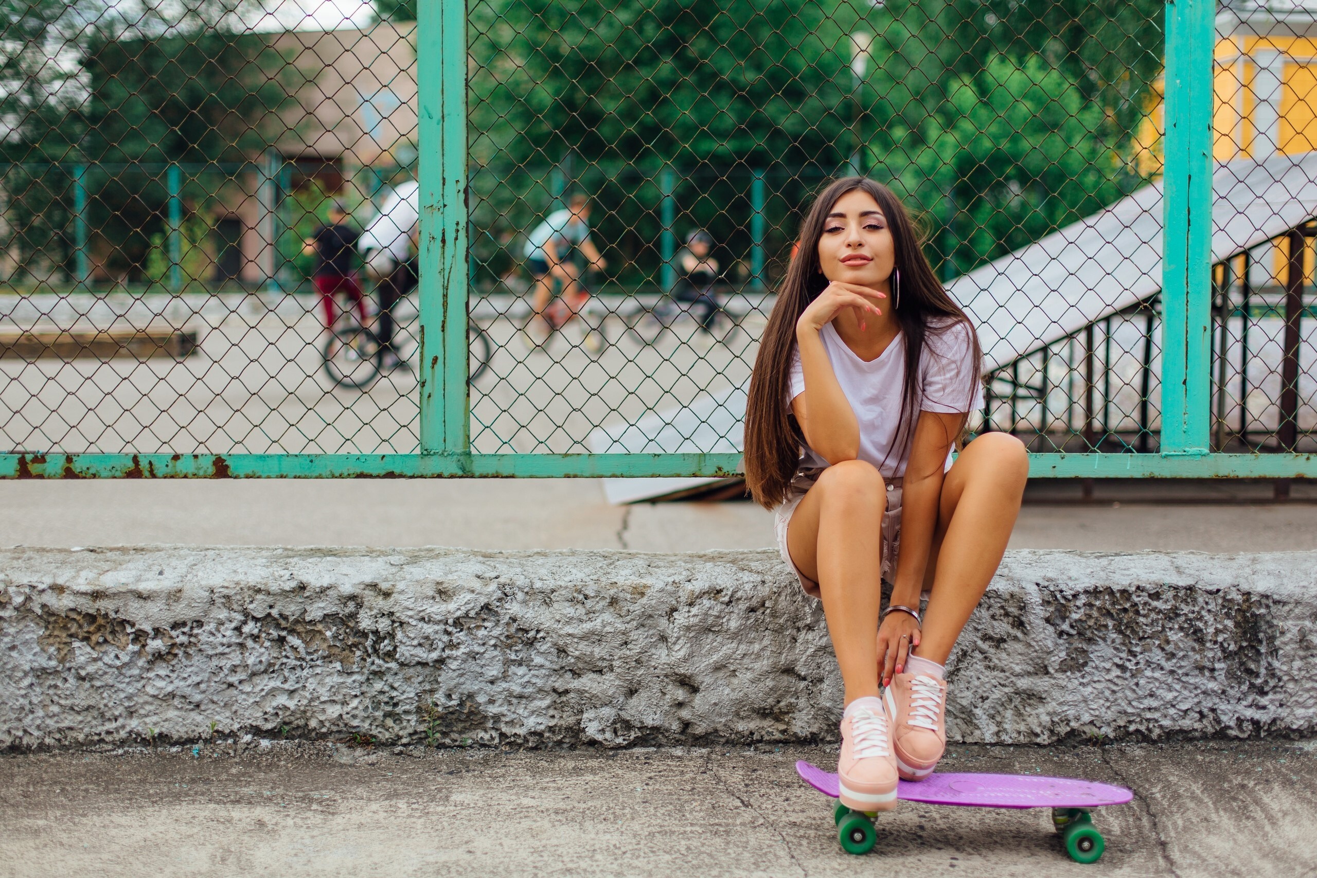 Girl Skateboarding: Pink skateboard deck, Green polyurethane wheels, Street recreational activity. 2560x1710 HD Background.