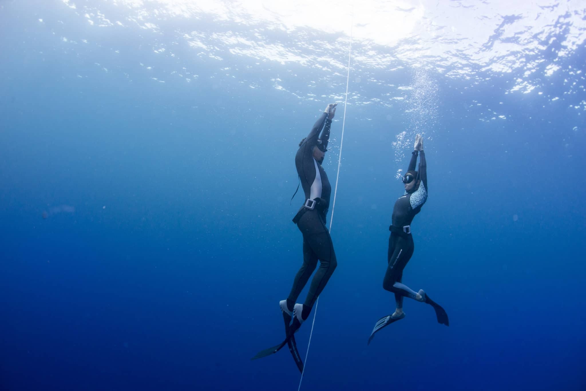 Freediving: A swimming couple, Adventurous underwater activity. 2050x1370 HD Background.