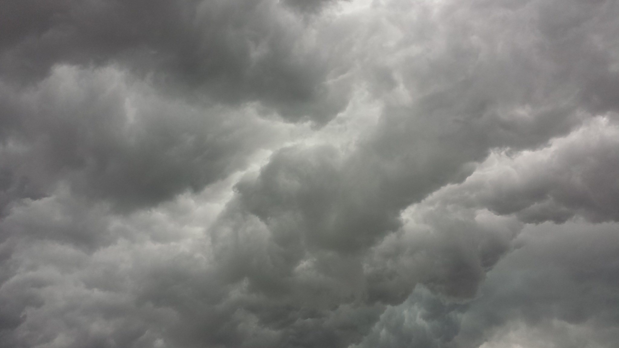 Gray Cloudy Sky: Nimbostratus clouds, Forming a thick, dark layer across the skies. 2050x1160 HD Background.