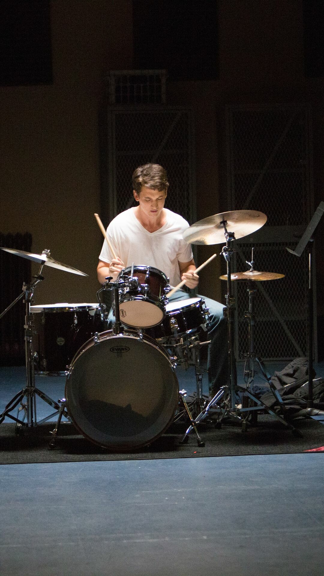 Whiplash: Miles Teller as Andrew Neiman, an ambitious young jazz drummer at Shaffer Conservatory. 1080x1920 Full HD Background.