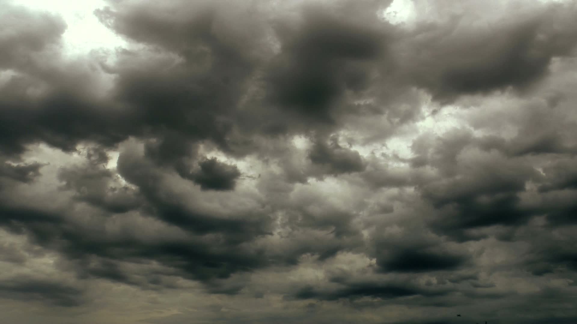Gray Cloudy Sky: Glimpse of the sun, A cloud with a deep bruised gray or blackish underside, An impending rain. 1920x1080 Full HD Wallpaper.