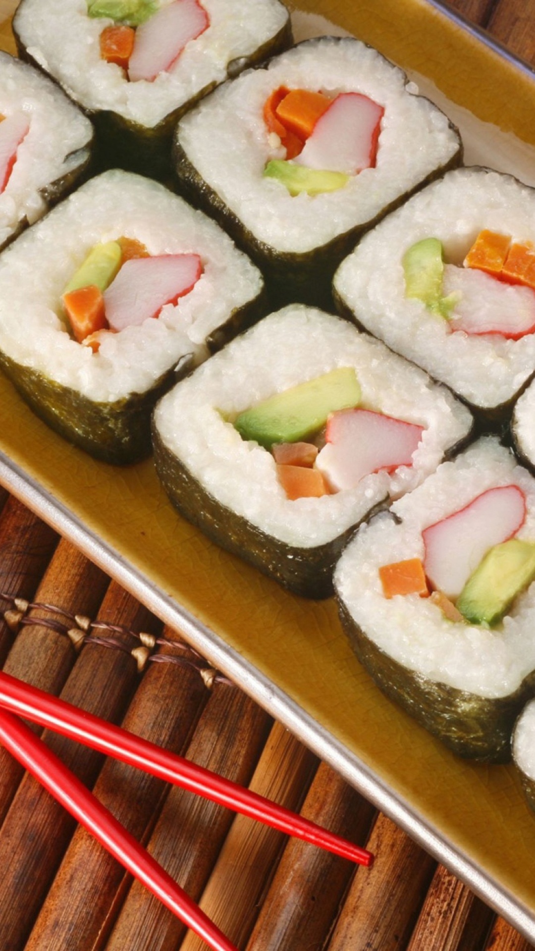 Sushi: California maki, an uramaki containing crab, avocado, and cucumber. 1080x1920 Full HD Background.