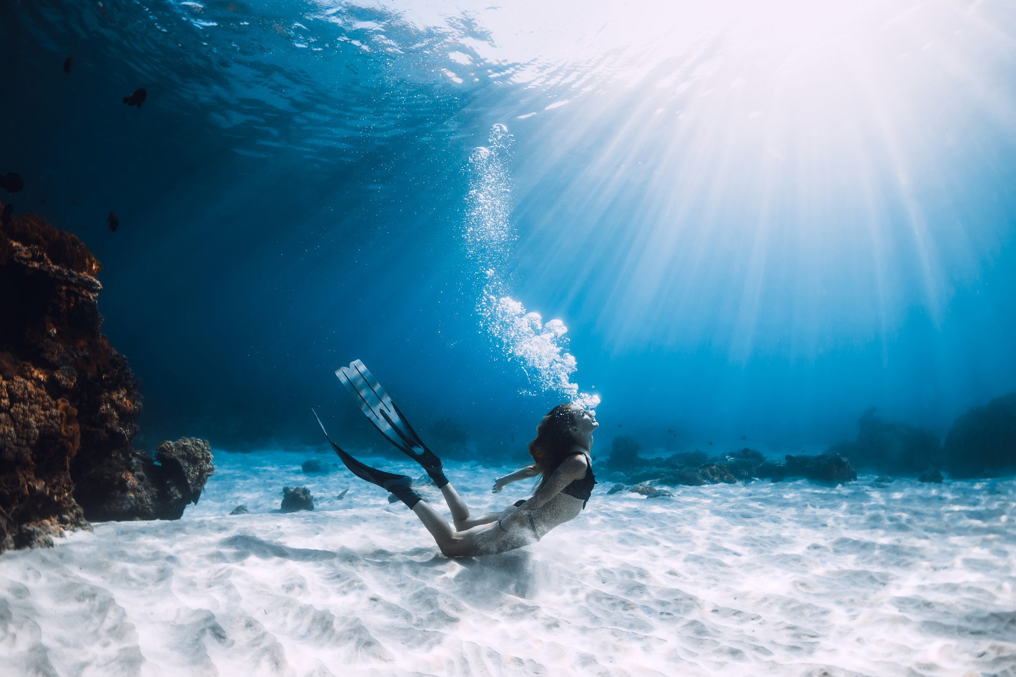Diving: A female freediver at the sandy sea bottom, Extreme water sport. 2050x1370 HD Wallpaper.
