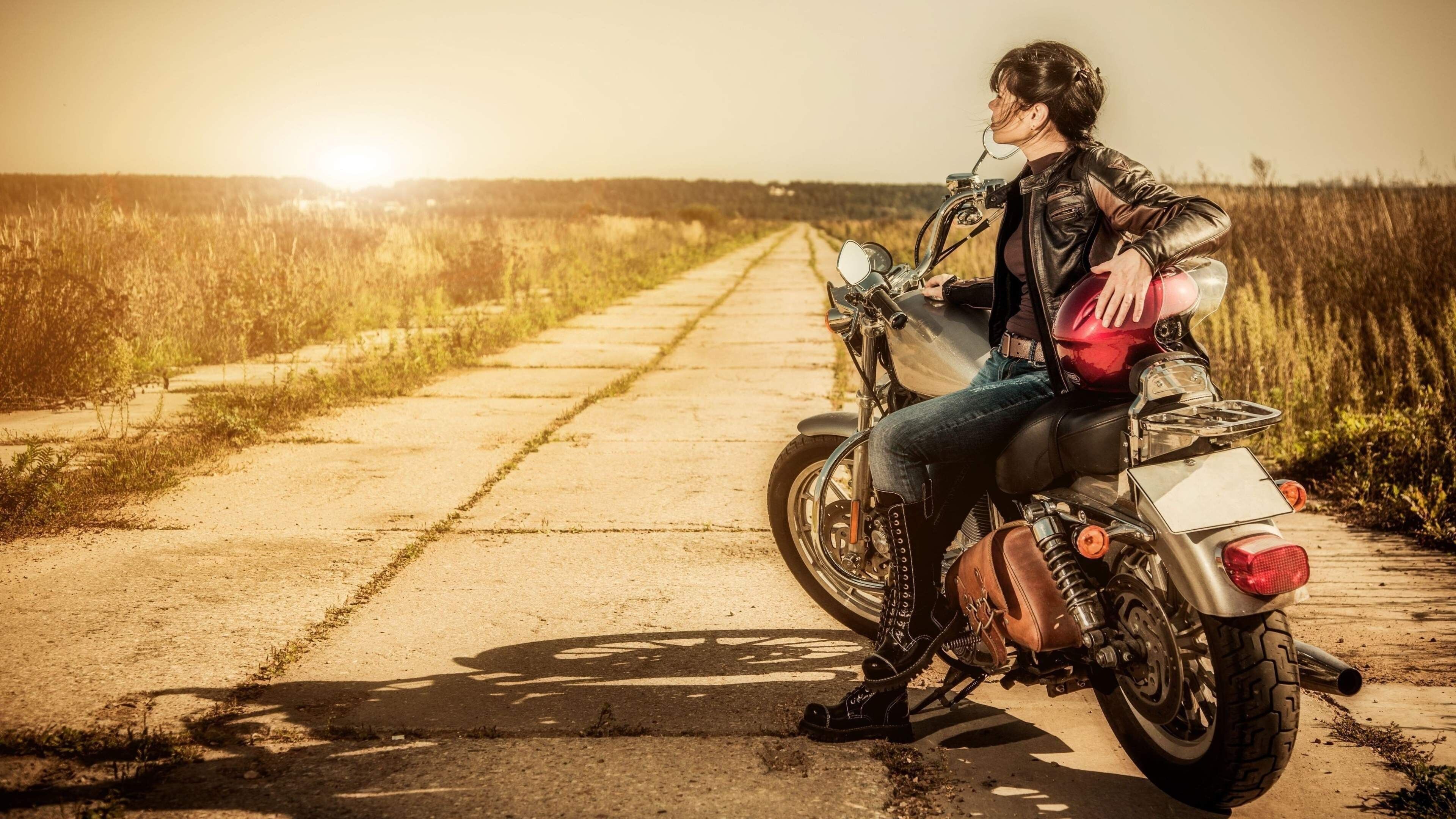 Girls and Motorcycles: Solo motorcycle touring, Biker clothing: Leather jacket, jeans, boots, Side bag. 3840x2160 4K Wallpaper.