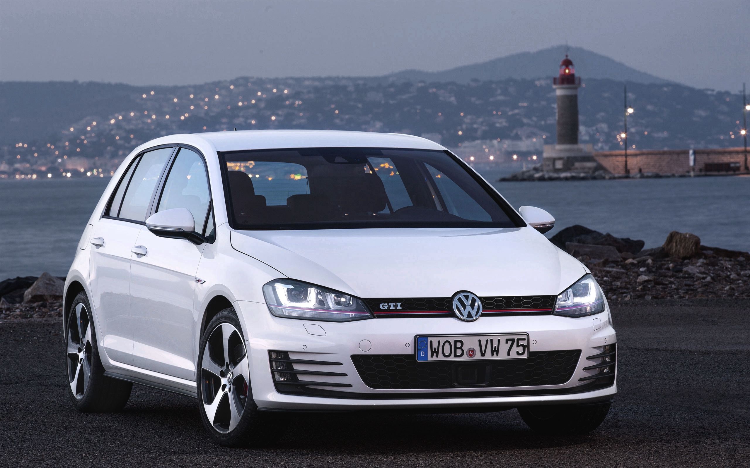 Golf GTI: A 3 or 5-door hatchback produced by Volkswagen since 1975, Lighthouse, Bay. 2560x1600 HD Wallpaper.