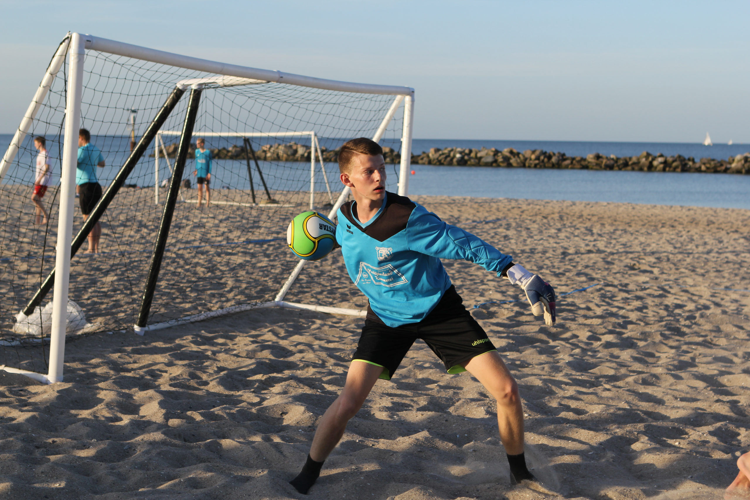 Beach Handball: A professional goalkeeper with a ball, Competitive sports. 2560x1710 HD Background.