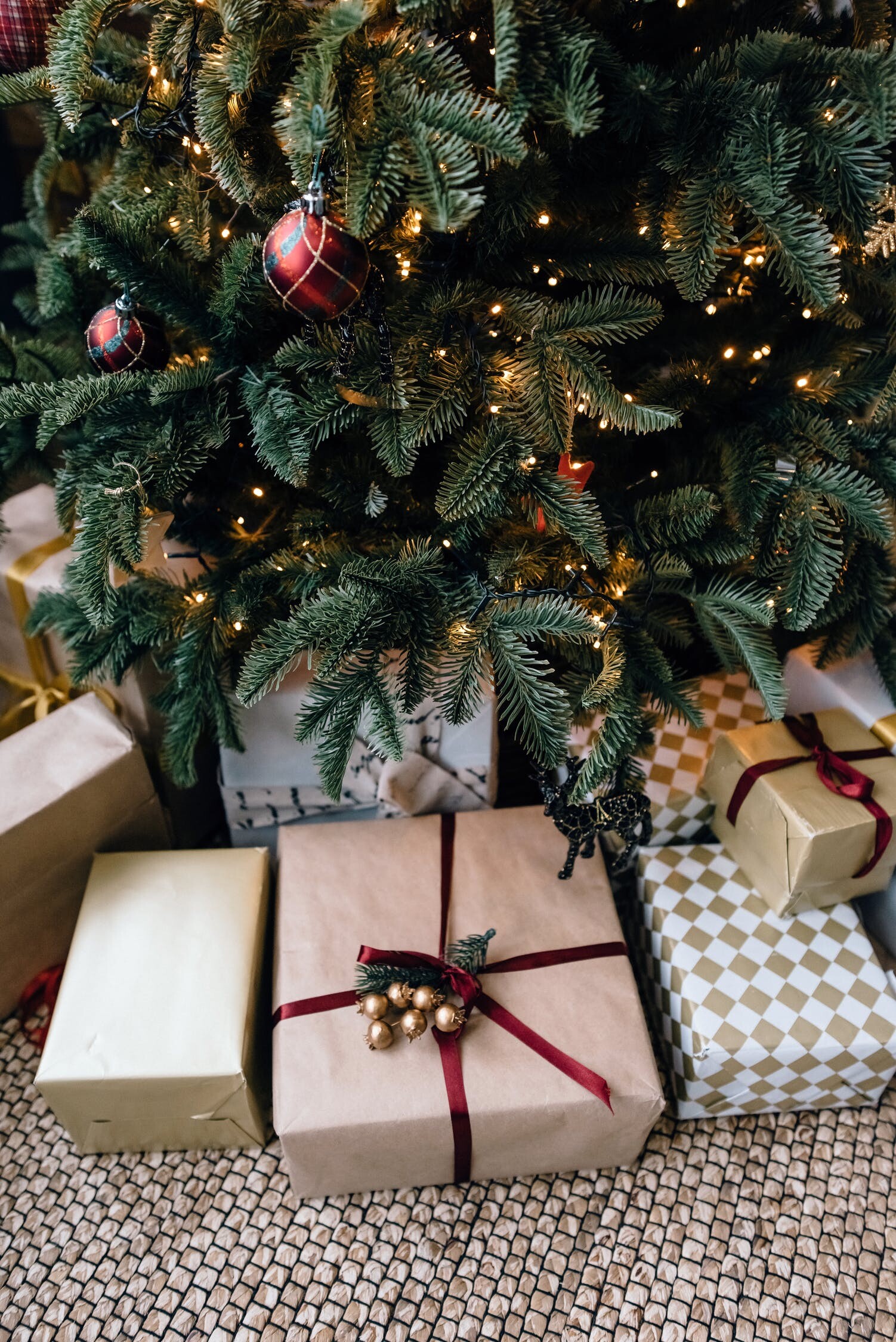 Christmas Gifts: Boxes wrapped brightly with a bow sitting under a Christmas Tree. 1510x2250 HD Wallpaper.