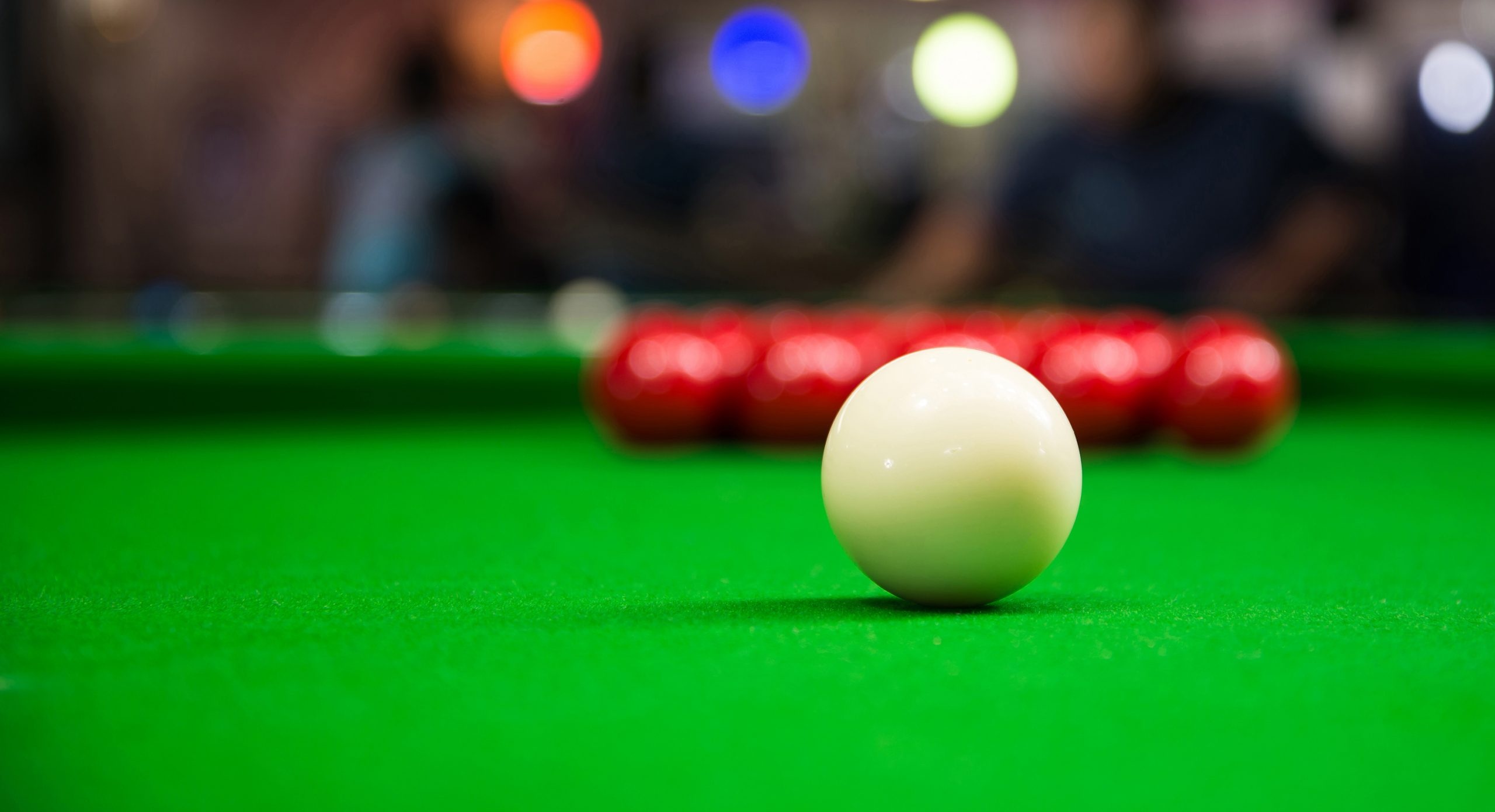 Snooker: A Classical English cue sport played on a rectangular table covered with a green cloth called baize. 2560x1400 HD Wallpaper.