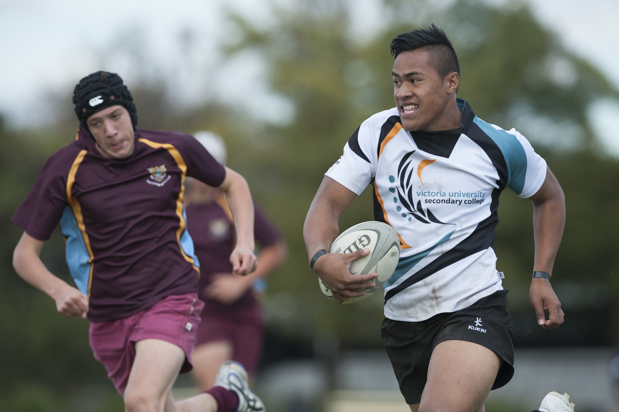 Rugby League: Victoria University Secondary College footballer holds a ball during the game. 2130x1420 HD Background.