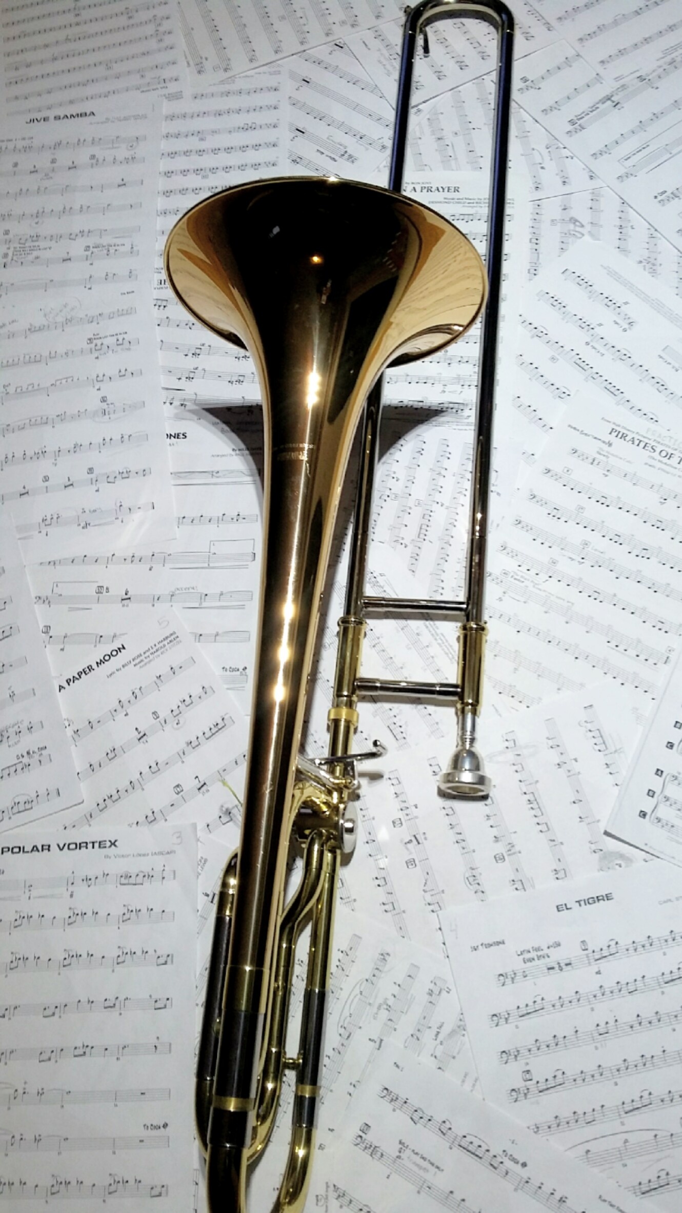 Trombone: A large brass instrument, Different tones are produced by moving the slide, Music notes. 1330x2370 HD Background.