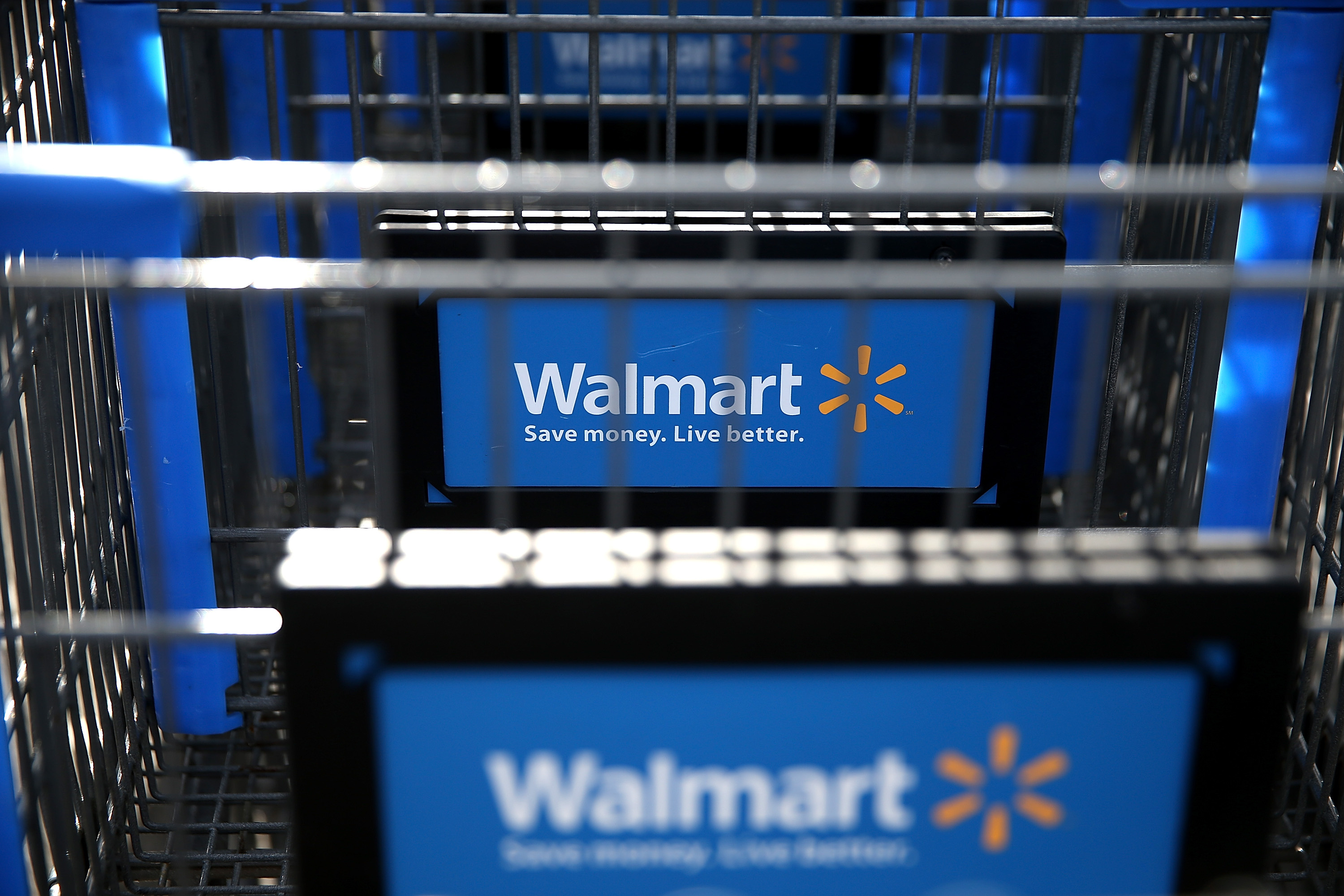 Walmart: A shopping cart, A chain with 10,585 stores and clubs in 24 countries, operating under 46 different names. 3000x2010 HD Background.