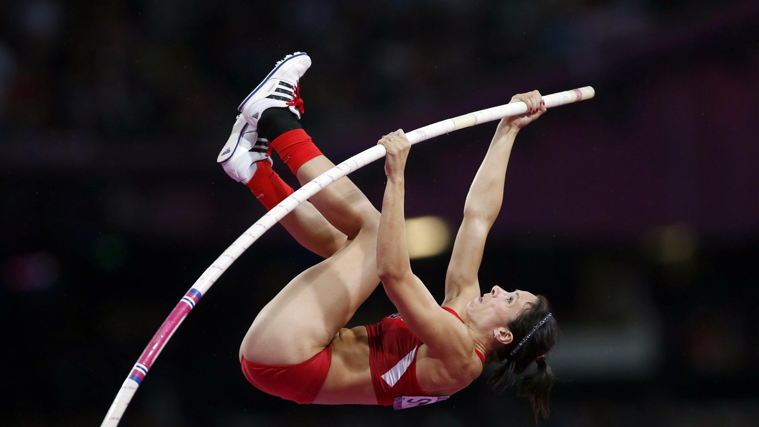 Pole Vaulting: Suhr, Isinbayeva, A leap for height over a horizontal bar in a track and field contest. 2560x1440 HD Background.