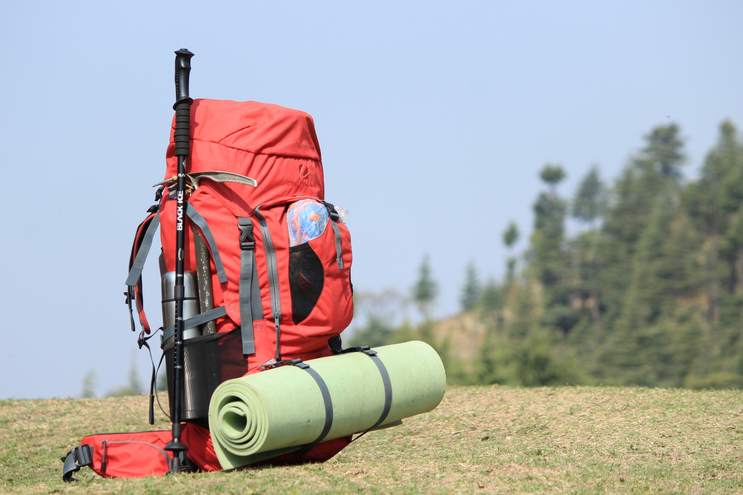 Backpacking: Hiking equipment - a backpack, survival gear, sleep system and some food/water supplies. 2600x1730 HD Background.