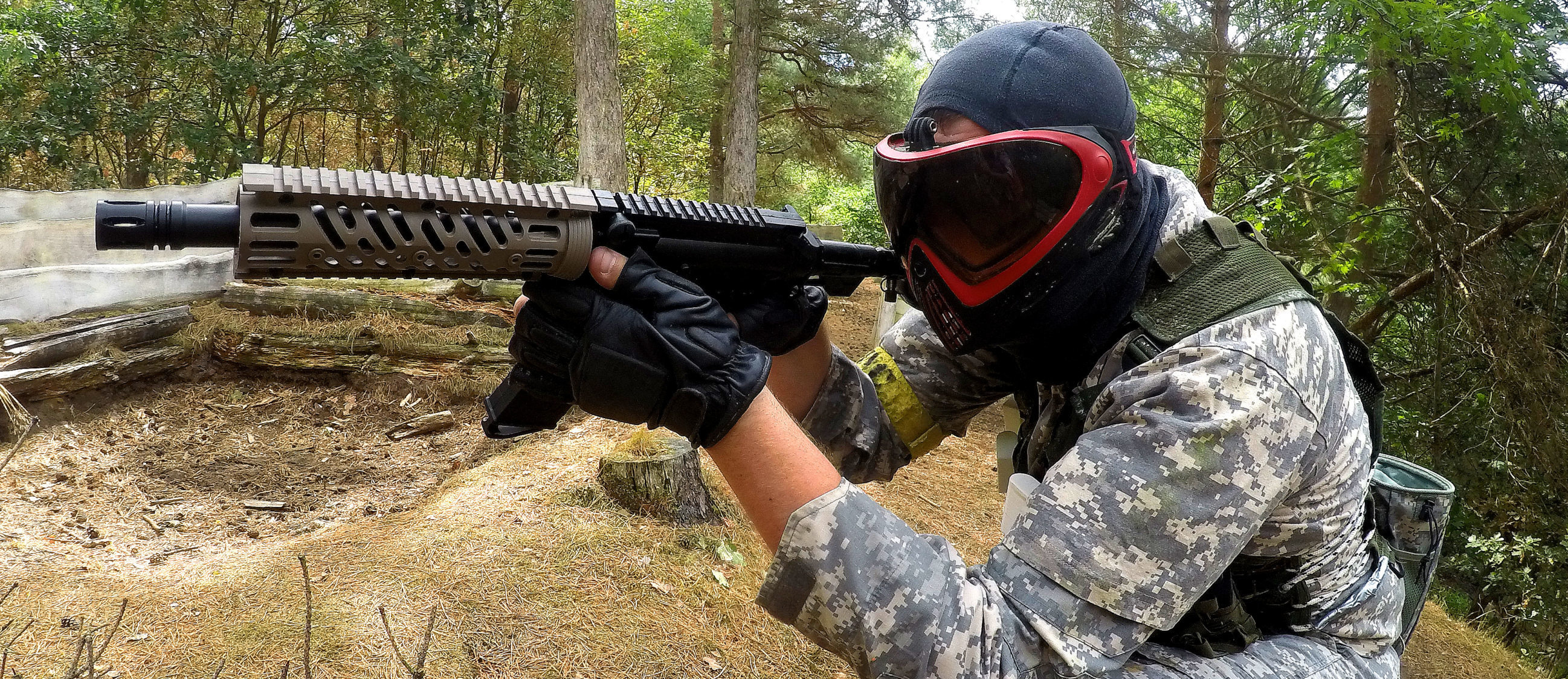 Paintball: An airsoft player equipped with an AR15 Close Quarters Battle rifle. 2600x1130 Dual Screen Background.