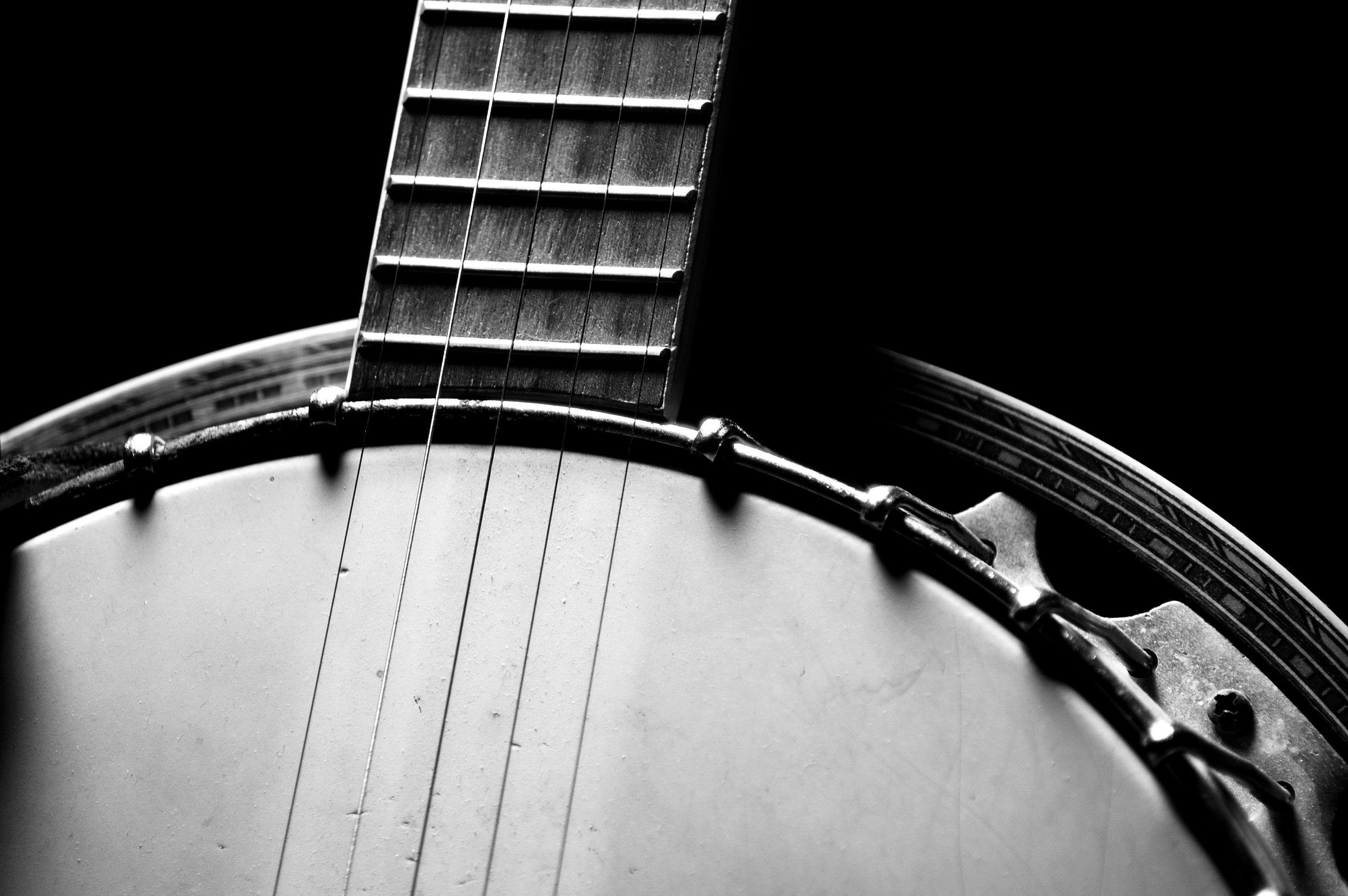 Banjo: A stringed musical instrument with a long neck and a hollow circular body. 3010x2000 HD Background.