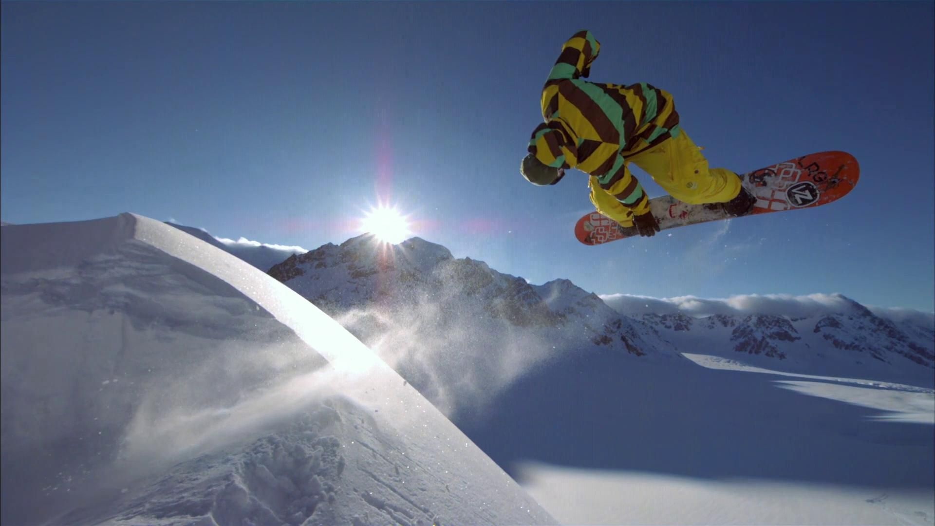 Snowboarding: Alpine snowboarding style, Big air combined style in the mountains, Red Bull professional snowboarder. 1920x1080 Full HD Background.