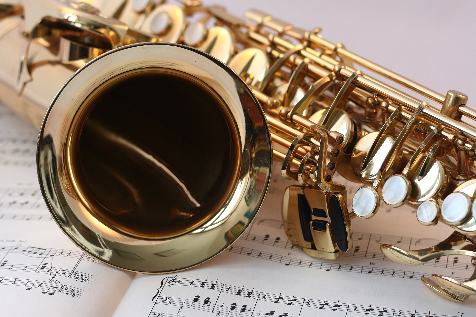 Saxophone: Sheet music, A metal musical instrument that belongs to the woodwind family. 1920x1280 HD Background.