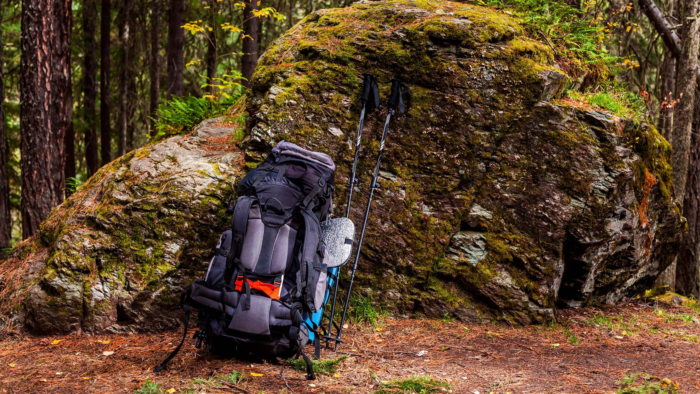 Backpacking: Hiking equipment - a backpack, survival gear, walking sticks, sleep system. 2400x1350 HD Wallpaper.