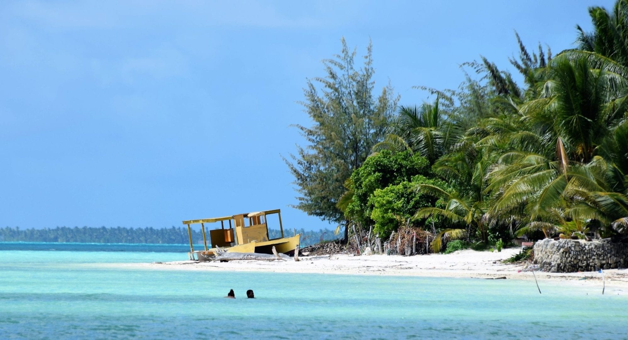 South Tarawa, Tranquil lagoon, Boat on the sand, Tropical serenity, 2000x1090 HD Desktop