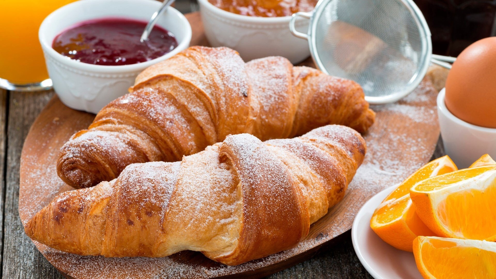 Croissant: Enjoyed plain or with powdered sugar, almond flakes, or sesame seeds. 1920x1080 Full HD Background.