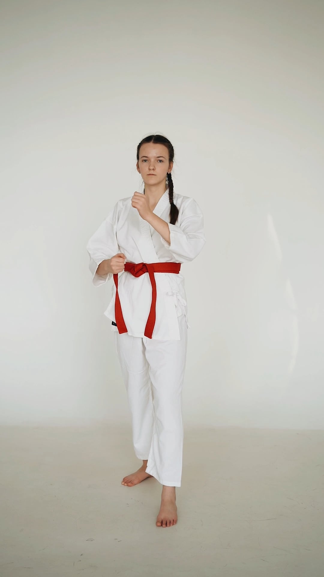 Karate: Red belt owner, A female karateka, Junior level combat sports. 1080x1920 Full HD Wallpaper.